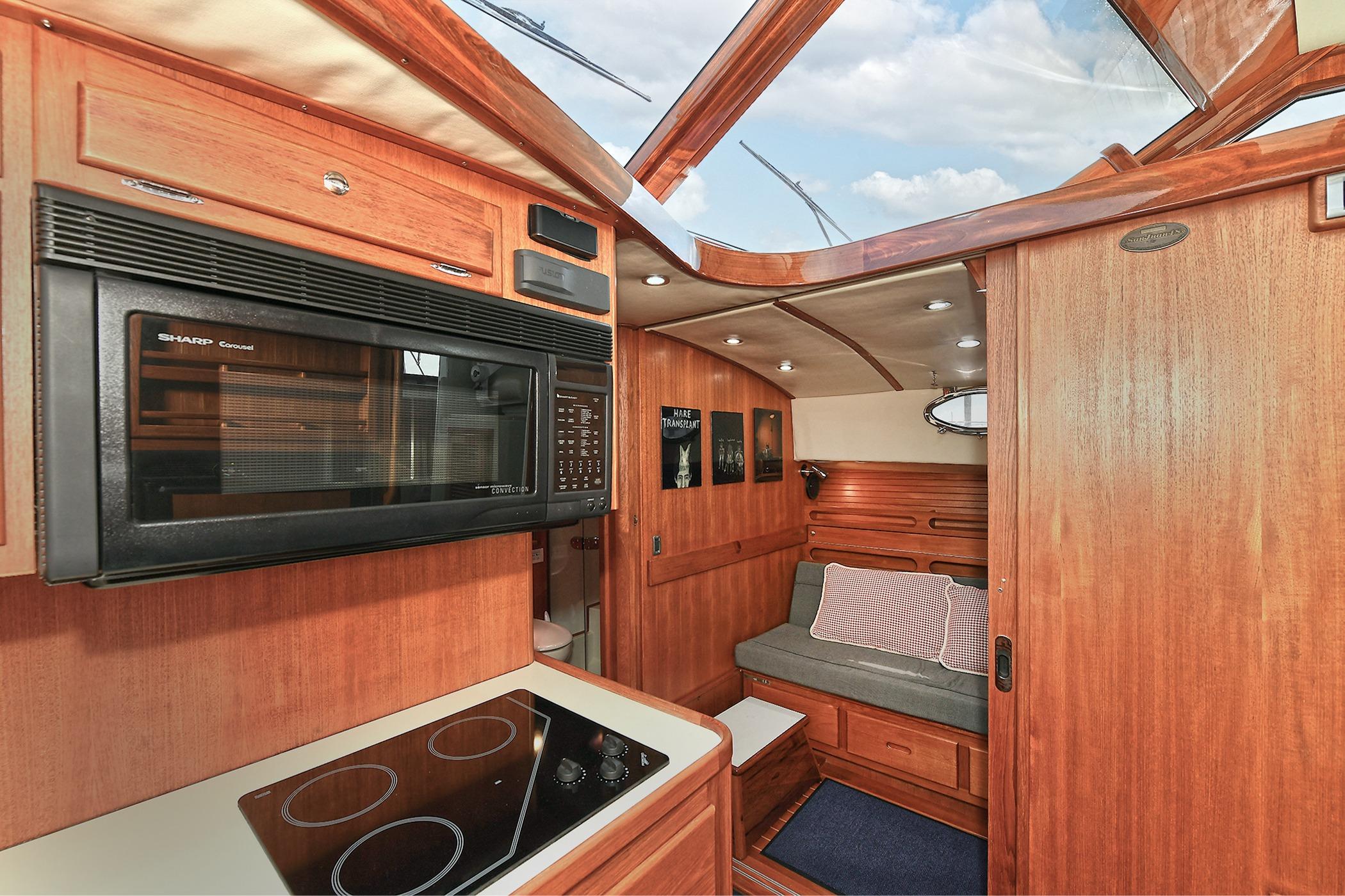 Luxurious 2005 San Juan Downeast Express yacht interior with wood finish and modern amenities.