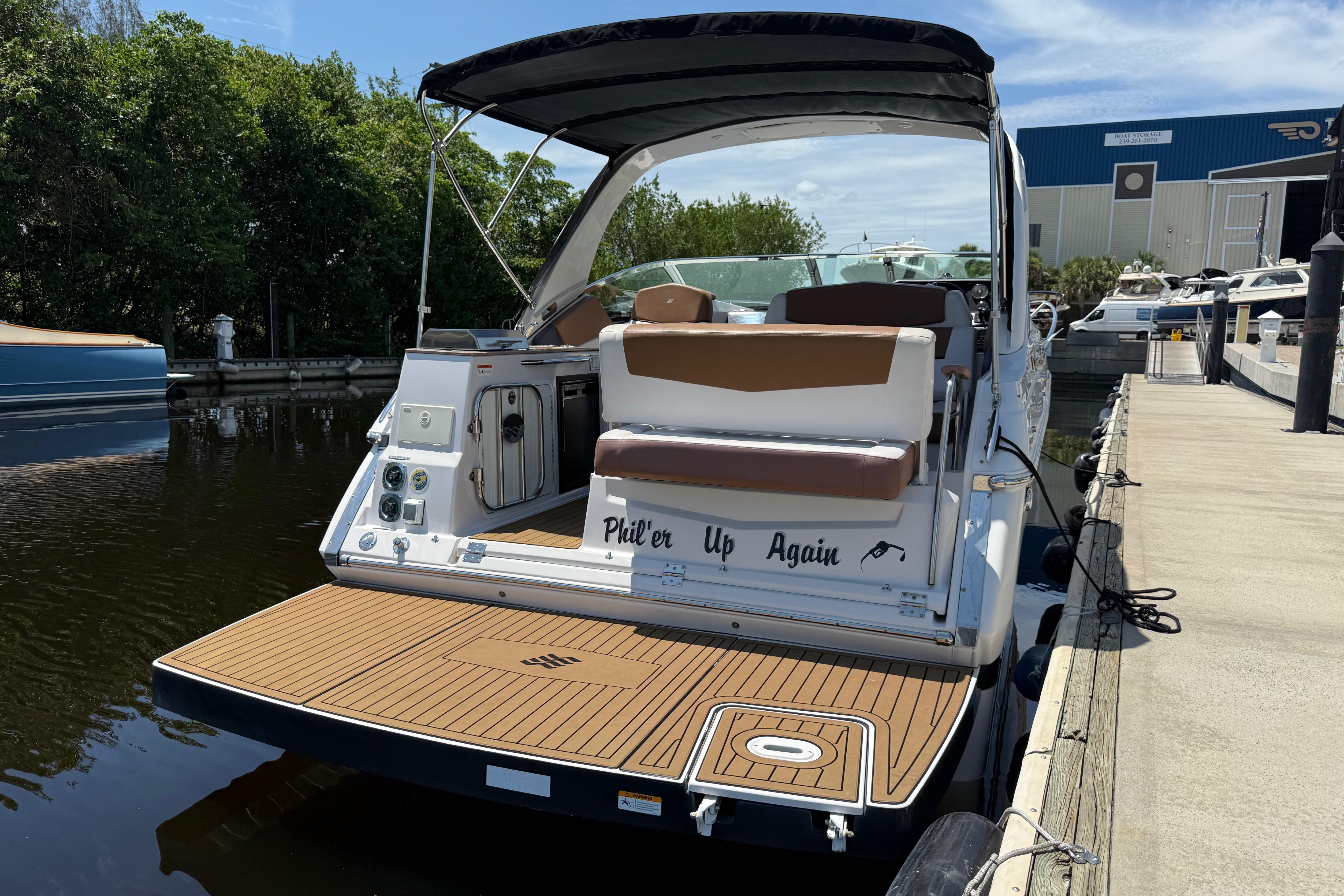 2017 Four Winns V275 boat docked, featuring a spacious deck and seating area.