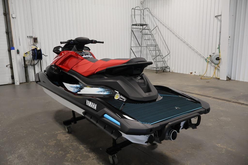 2026 Yamaha WaveRunner VX Deluxe in a garage, showcasing sleek design and vibrant colors.