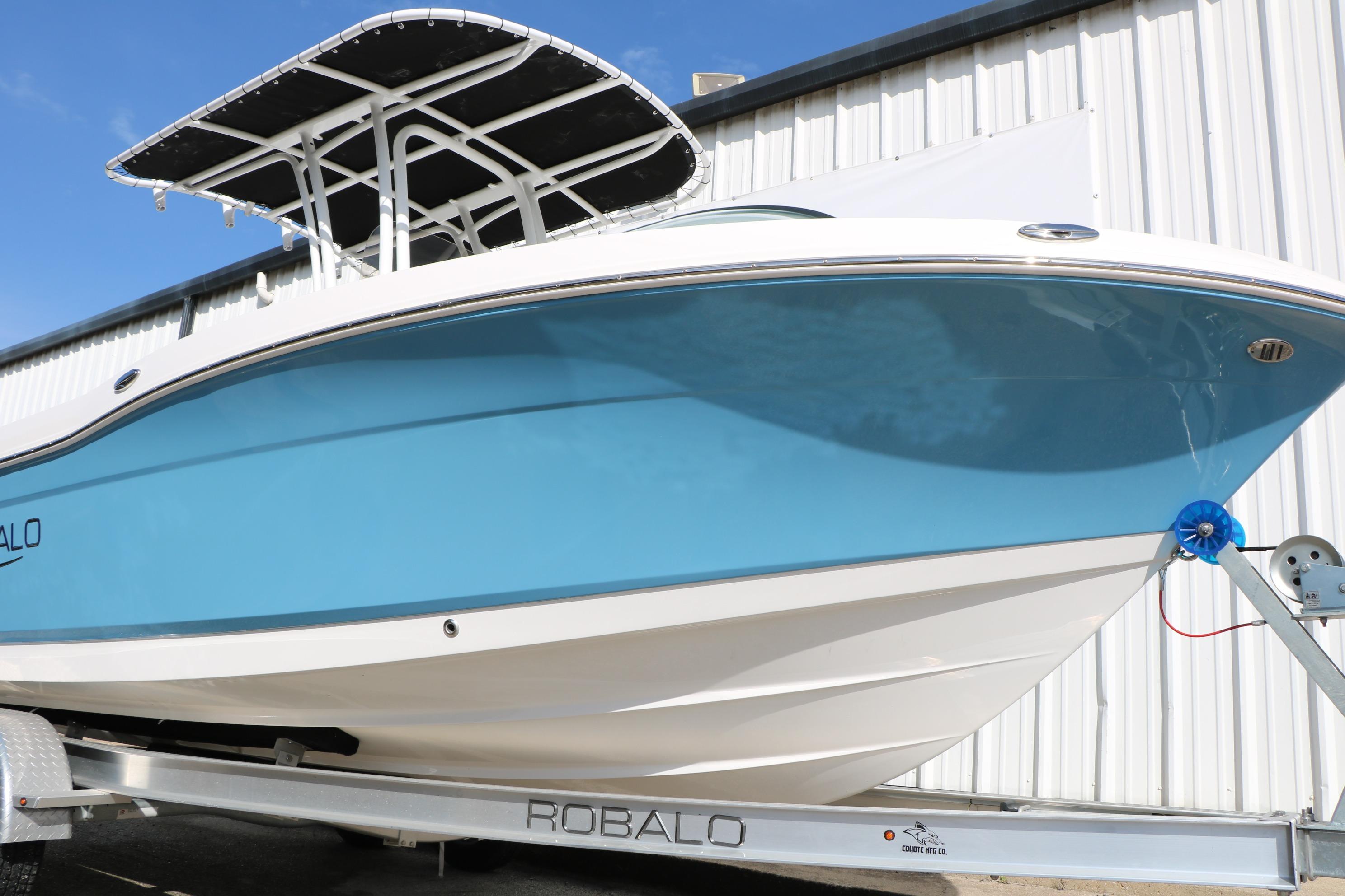 2026 Robalo R200 Center Console boat on trailer, blue hull, white trim, outdoor display.