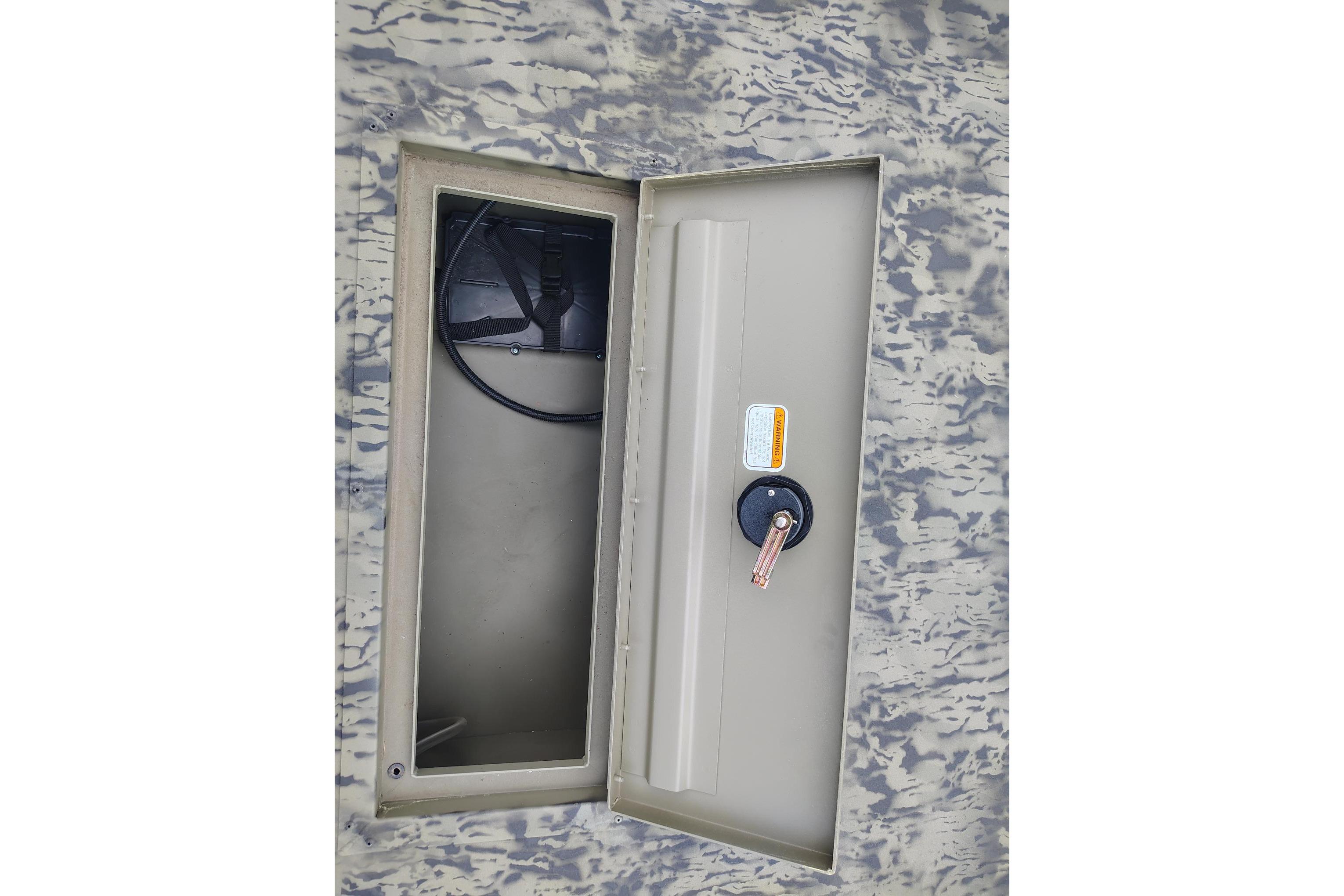 Open storage compartment on 2026 Tracker Grizzly 1654 T Sportsman boat.