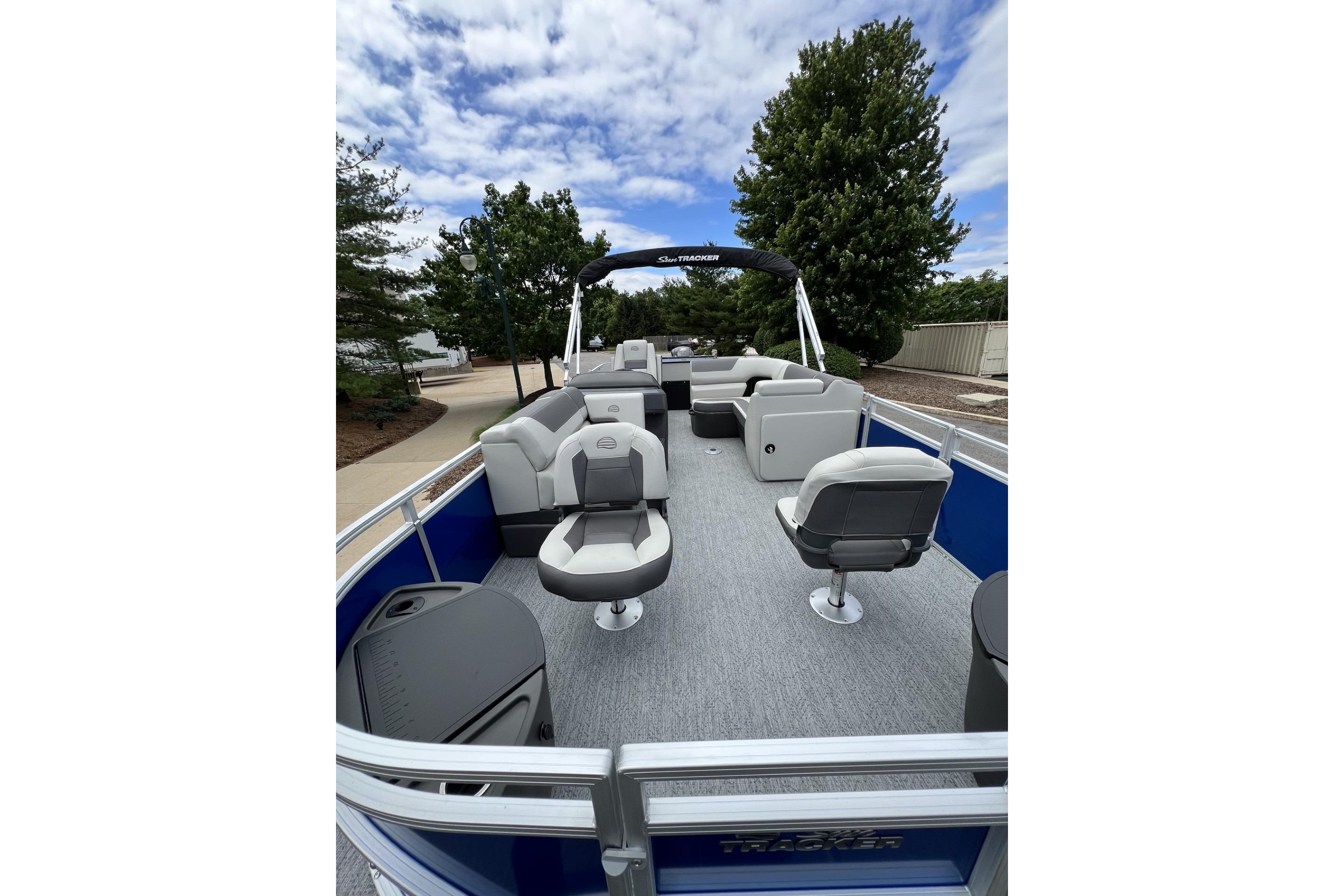2026 Sun Tracker Fishin' Barge 20 DLX pontoon boat with spacious seating and canopy.