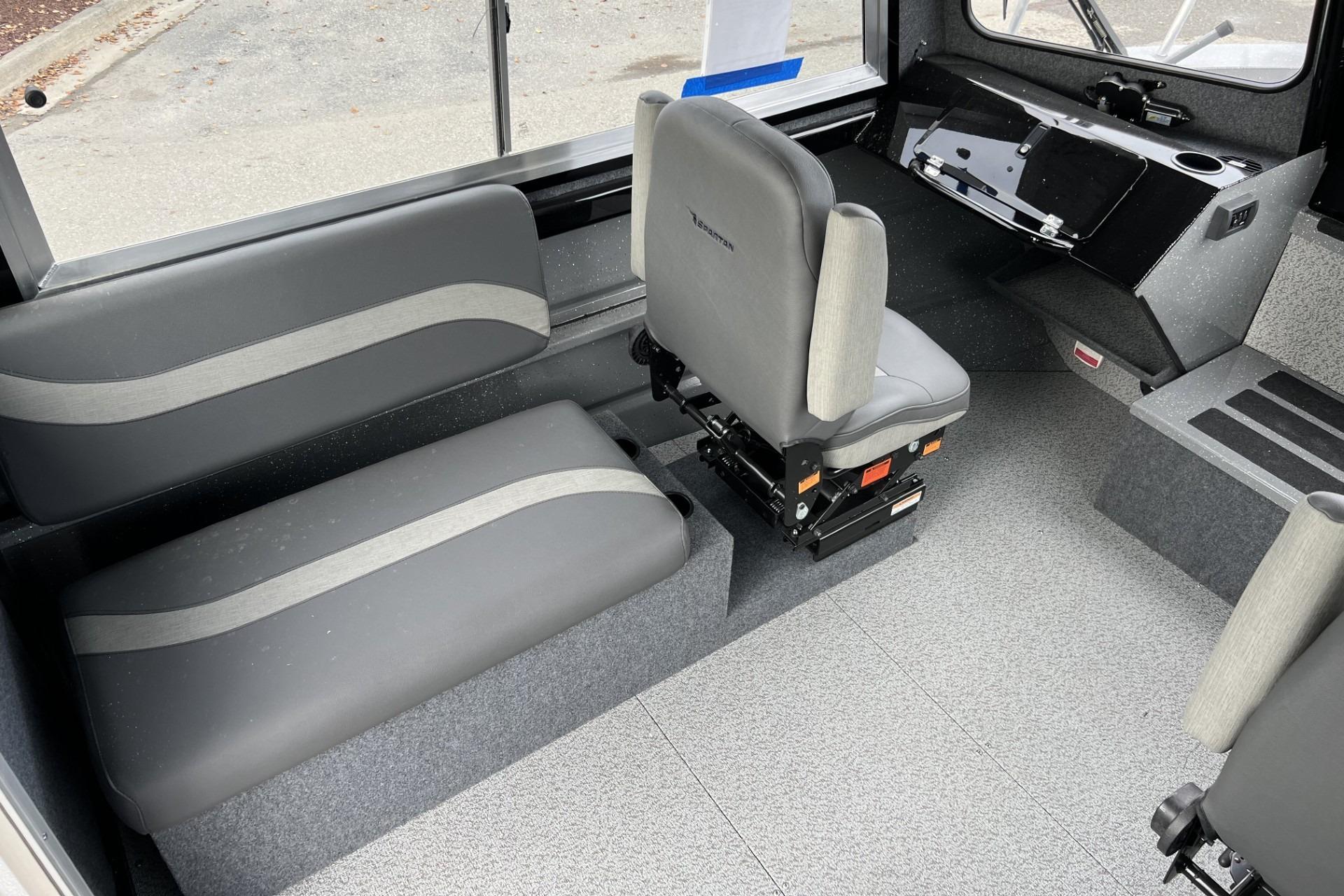 2024 Spartan 220 Maximus interior with gray seating and modern dashboard design.
