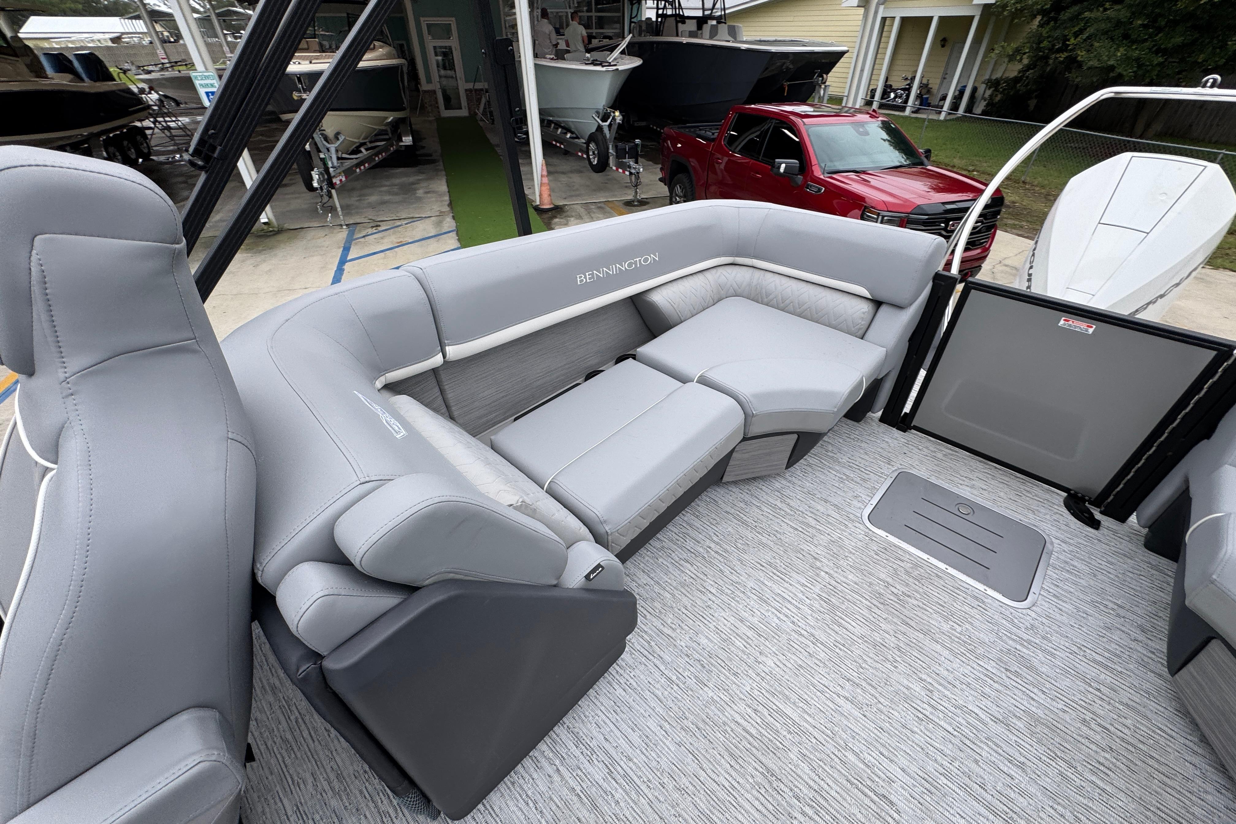2027 Bennington 24 MFB boat interior with luxurious gray seating and modern design.