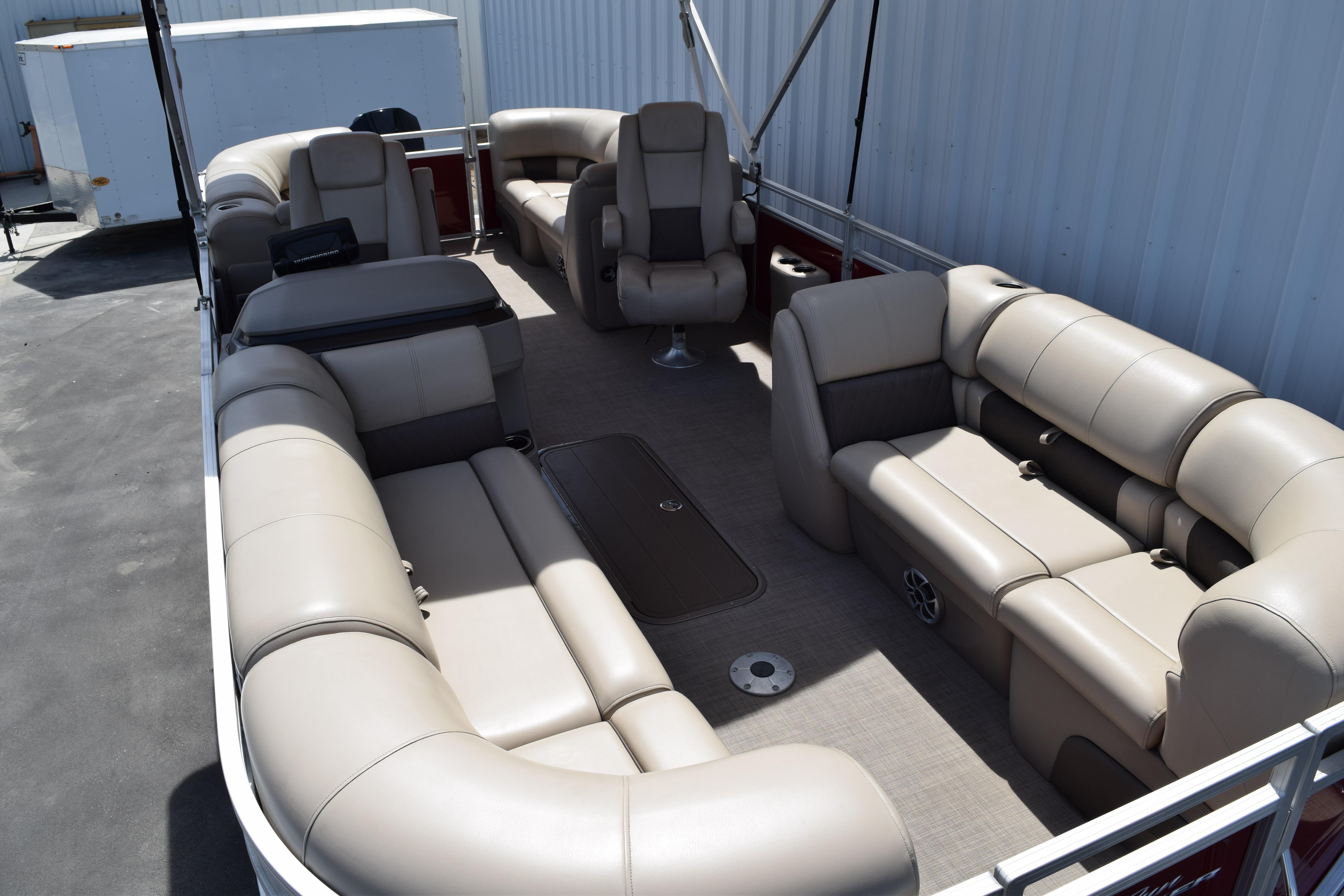2025 Sun Tracker Party Barge 22 XP3 interior with beige seating and spacious layout.