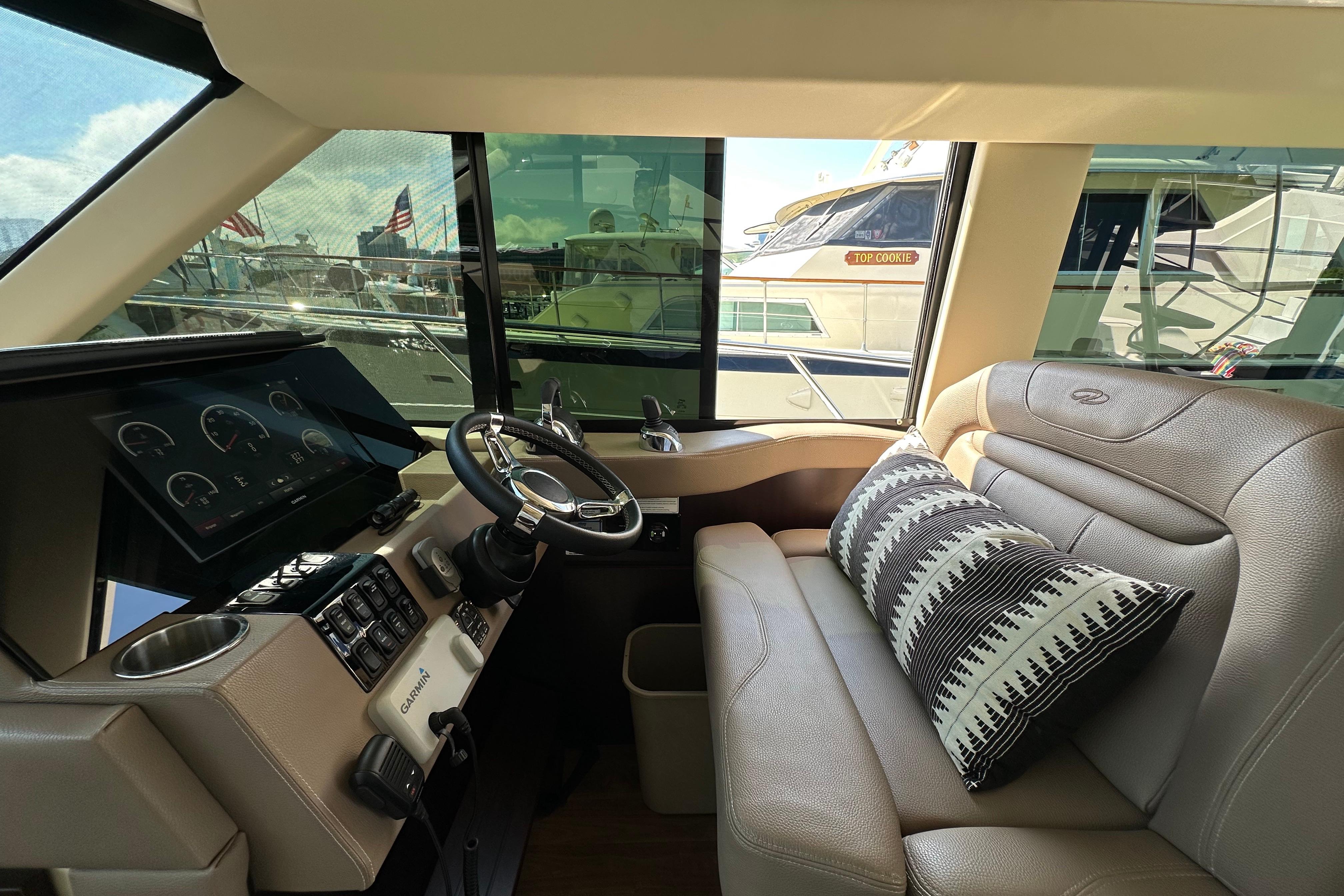 Luxurious interior of 2019 Regal 42 Fly yacht with modern helm and plush seating.
