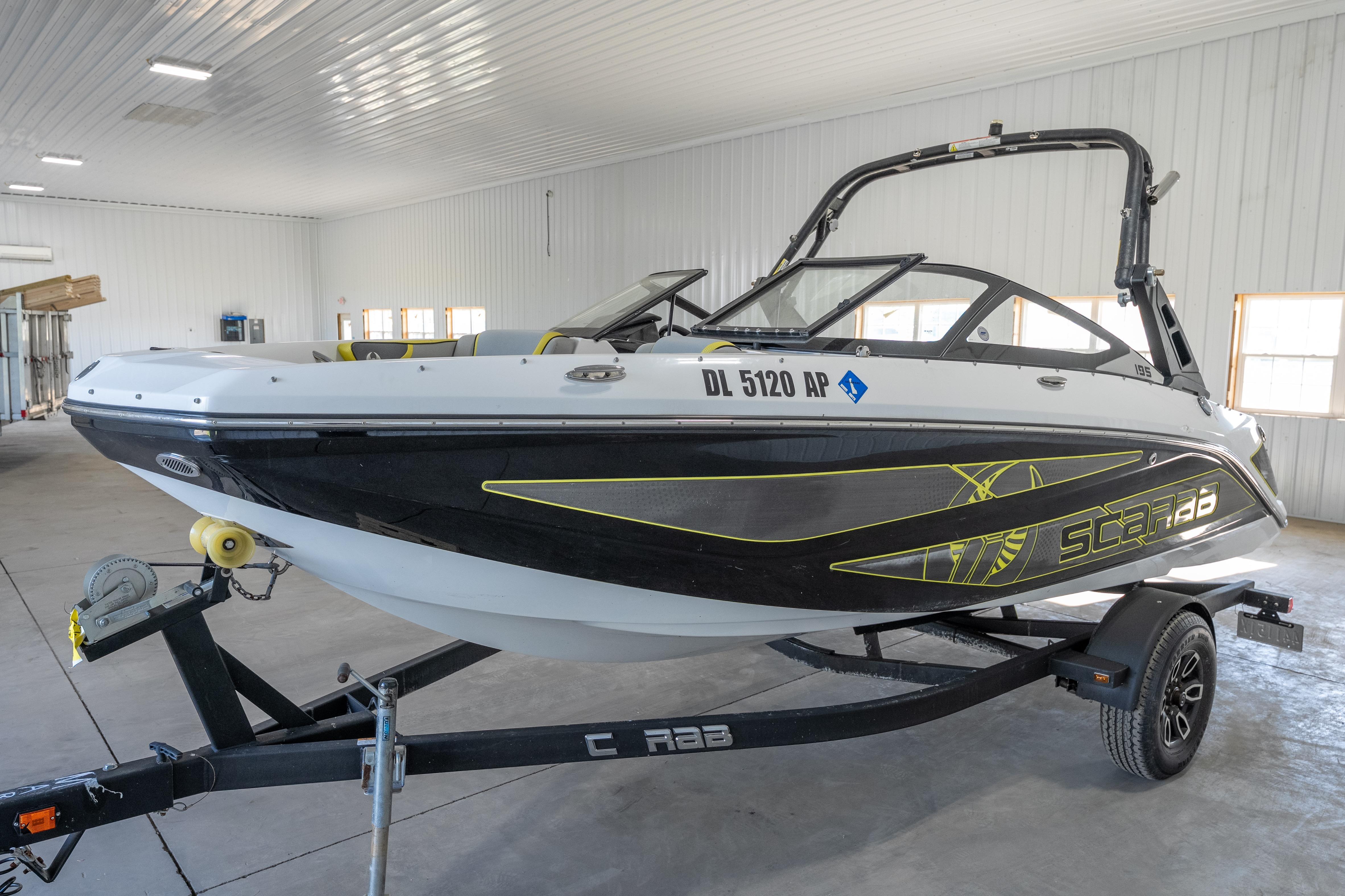 2023 Scarab 195 ID boat on trailer in indoor storage facility.