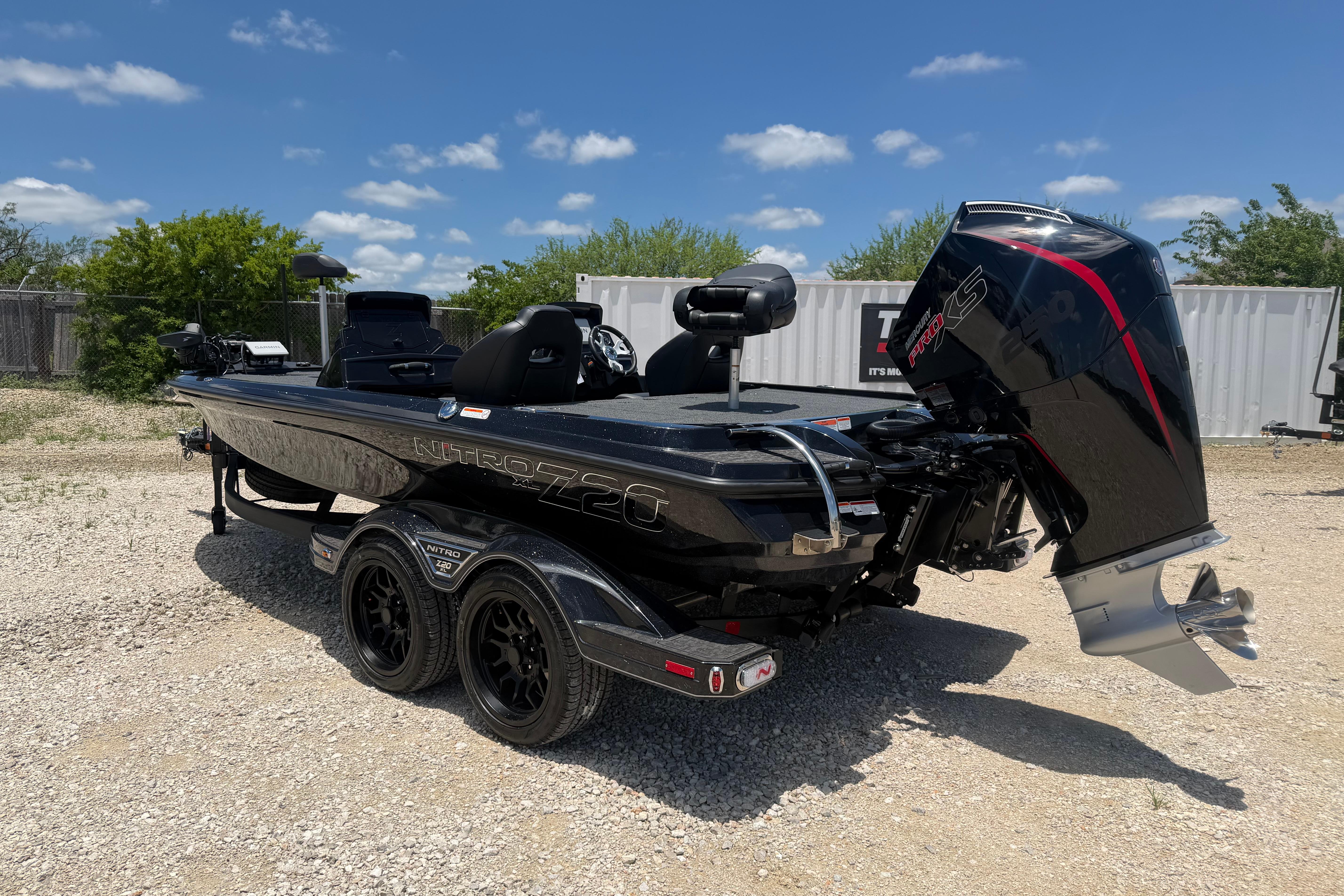 2026 Nitro Z20 XL Pro boat with powerful engine, parked on gravel under blue sky.