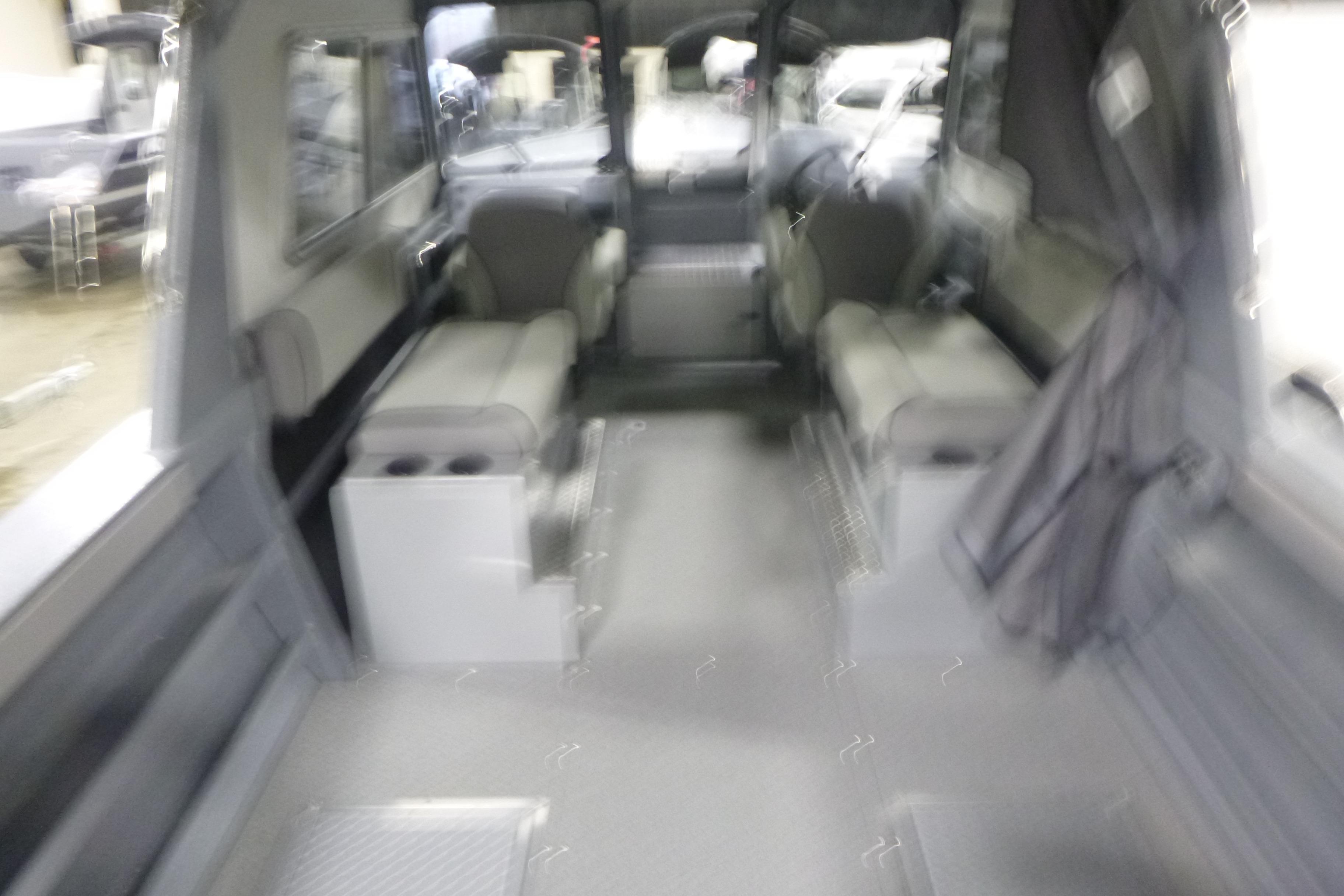 Interior of 2026 KingFisher 2425 Escape HT boat, featuring seating and storage.