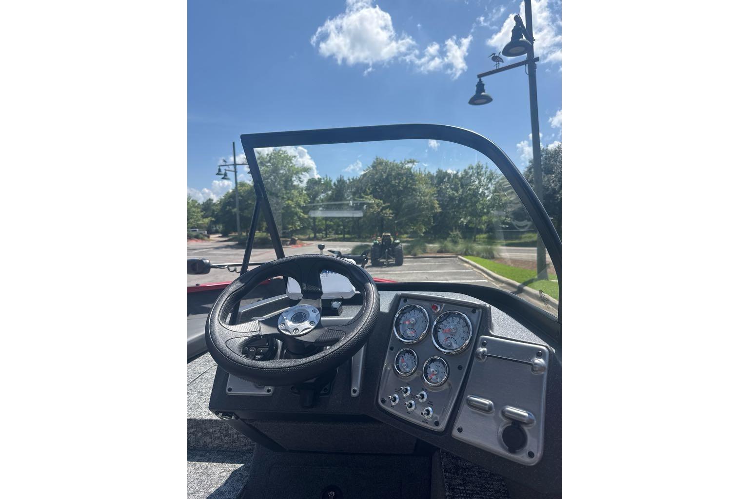 Interior view of 2026 Tracker Pro Guide V-175 Combo boat, featuring steering wheel and dashboard.