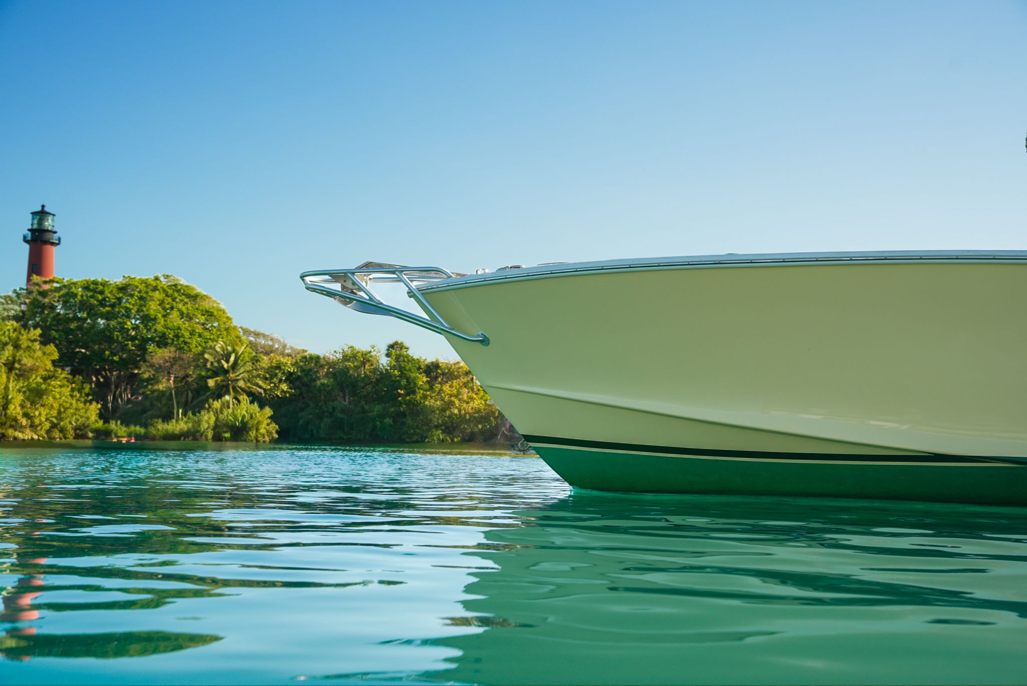 1985 Ocean Master 28 boat on calm water with lighthouse in background.