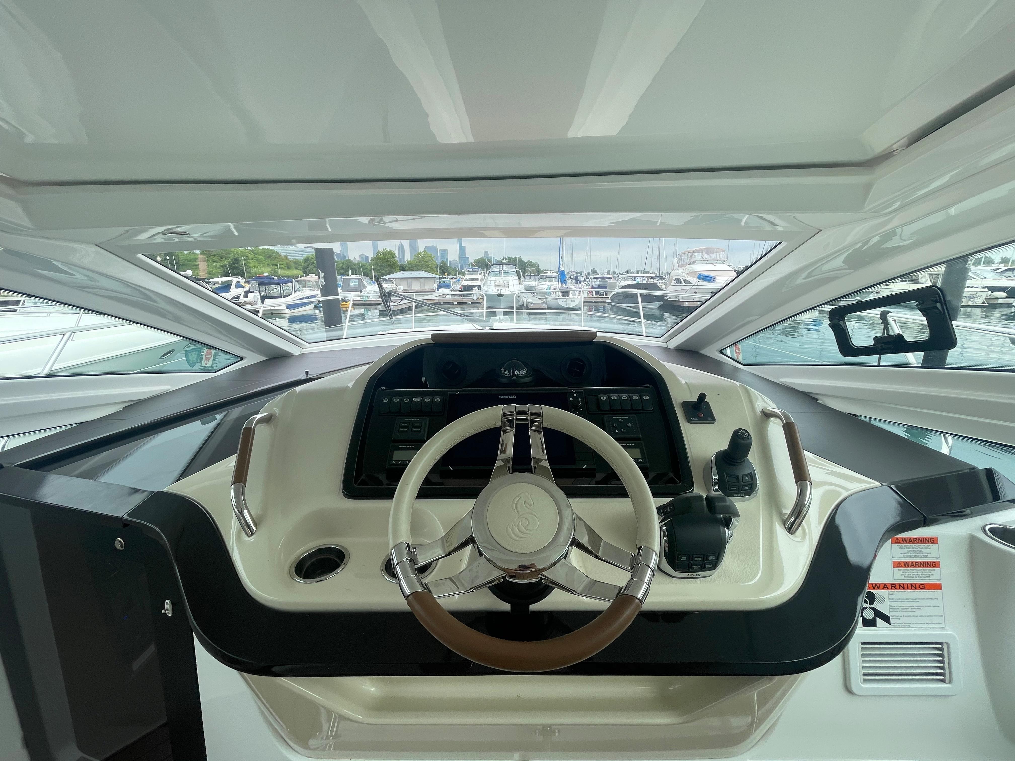 Beneteau Gran Turismo 40 helm, 2018 model, with marina view in background.