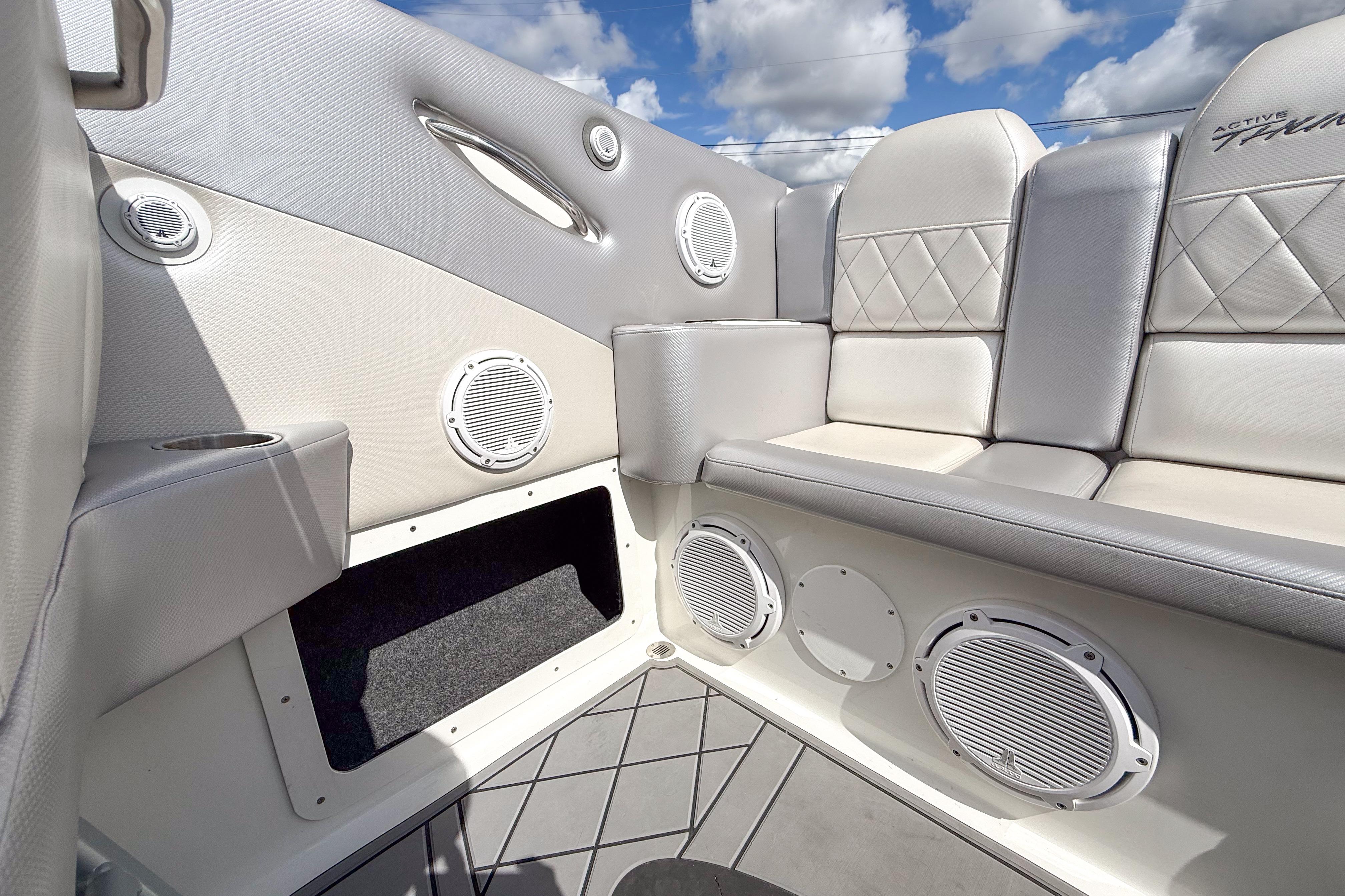Luxurious interior of 2002 Active Thunder 37 boat with plush seating and built-in speakers.
