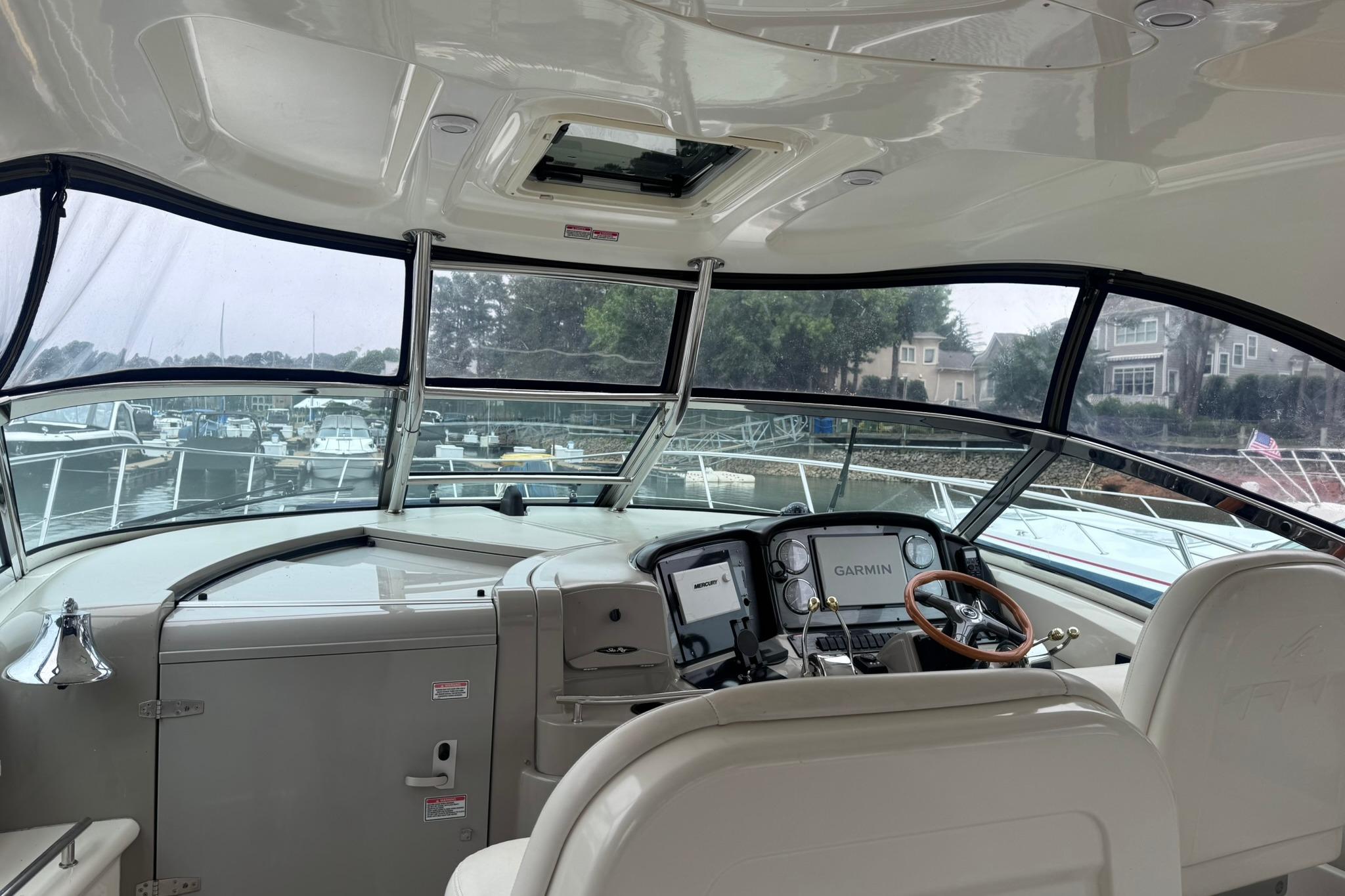 Interior view of 2004 Sea Ray 390 Sundancer yacht cockpit with Garmin navigation system.