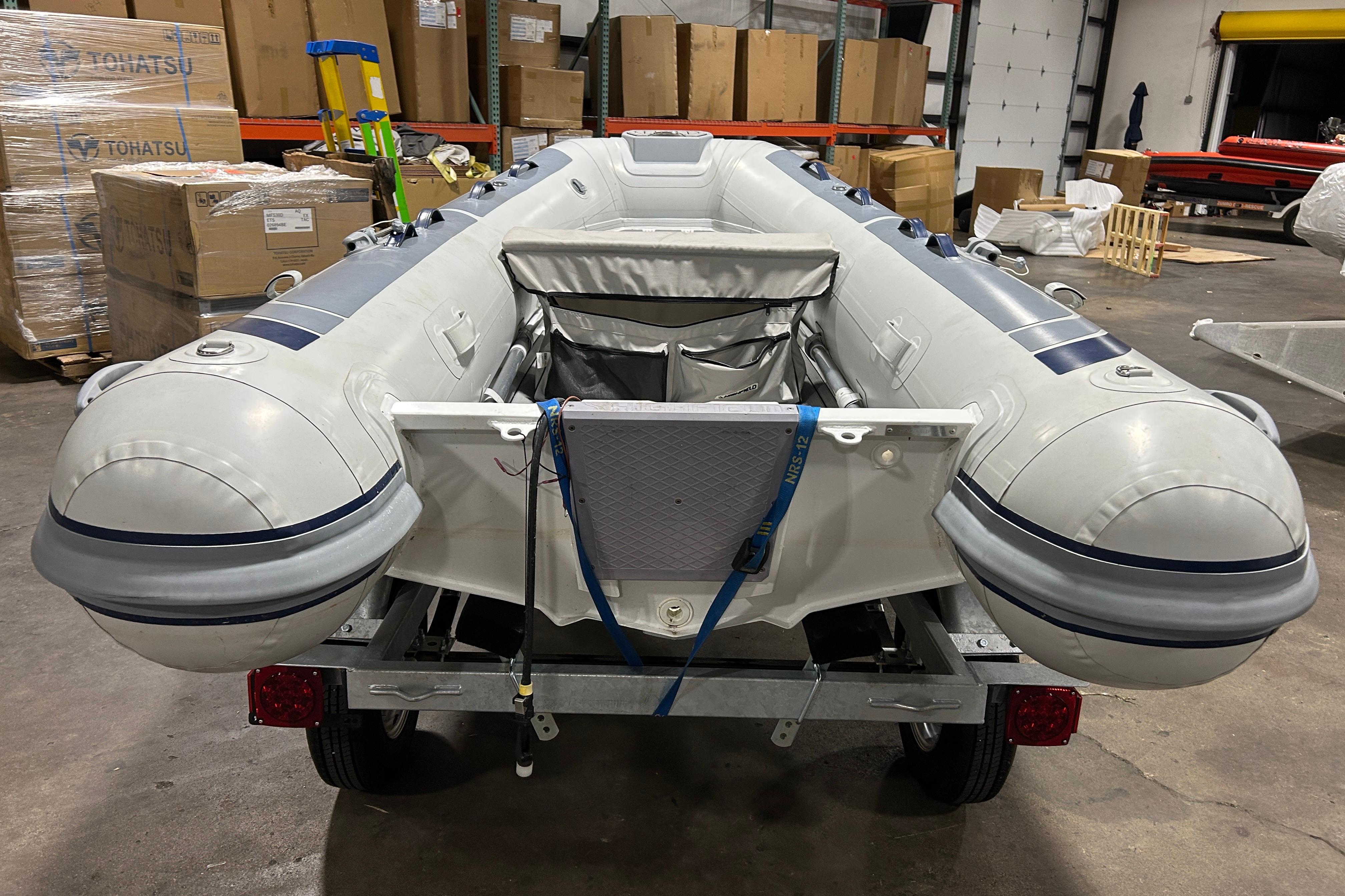 2023 Highfield Classic 310 inflatable boat in warehouse, secured on trailer.
