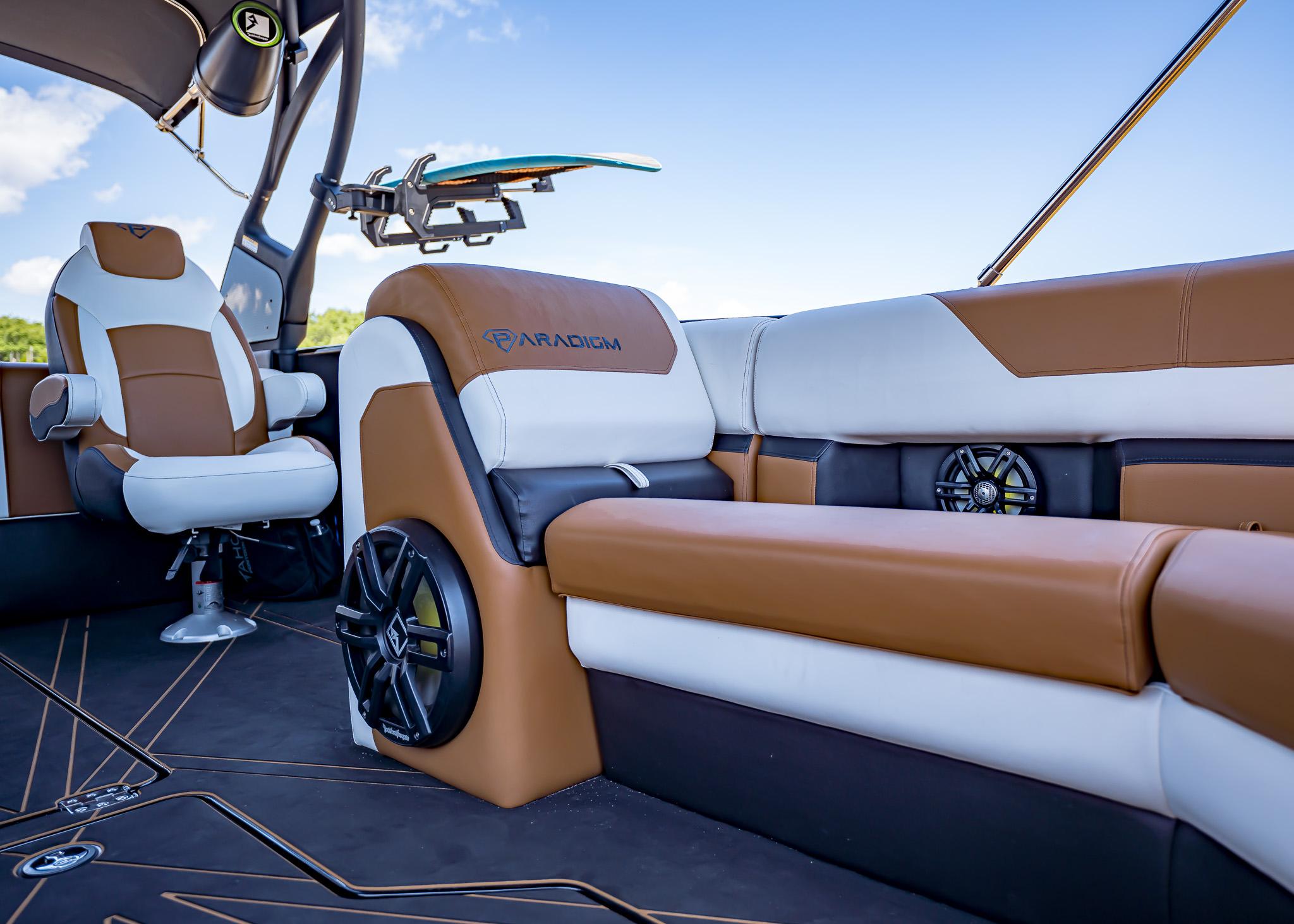 Luxurious interior of 2025 Paradigm 236 boat with brown and white seating.