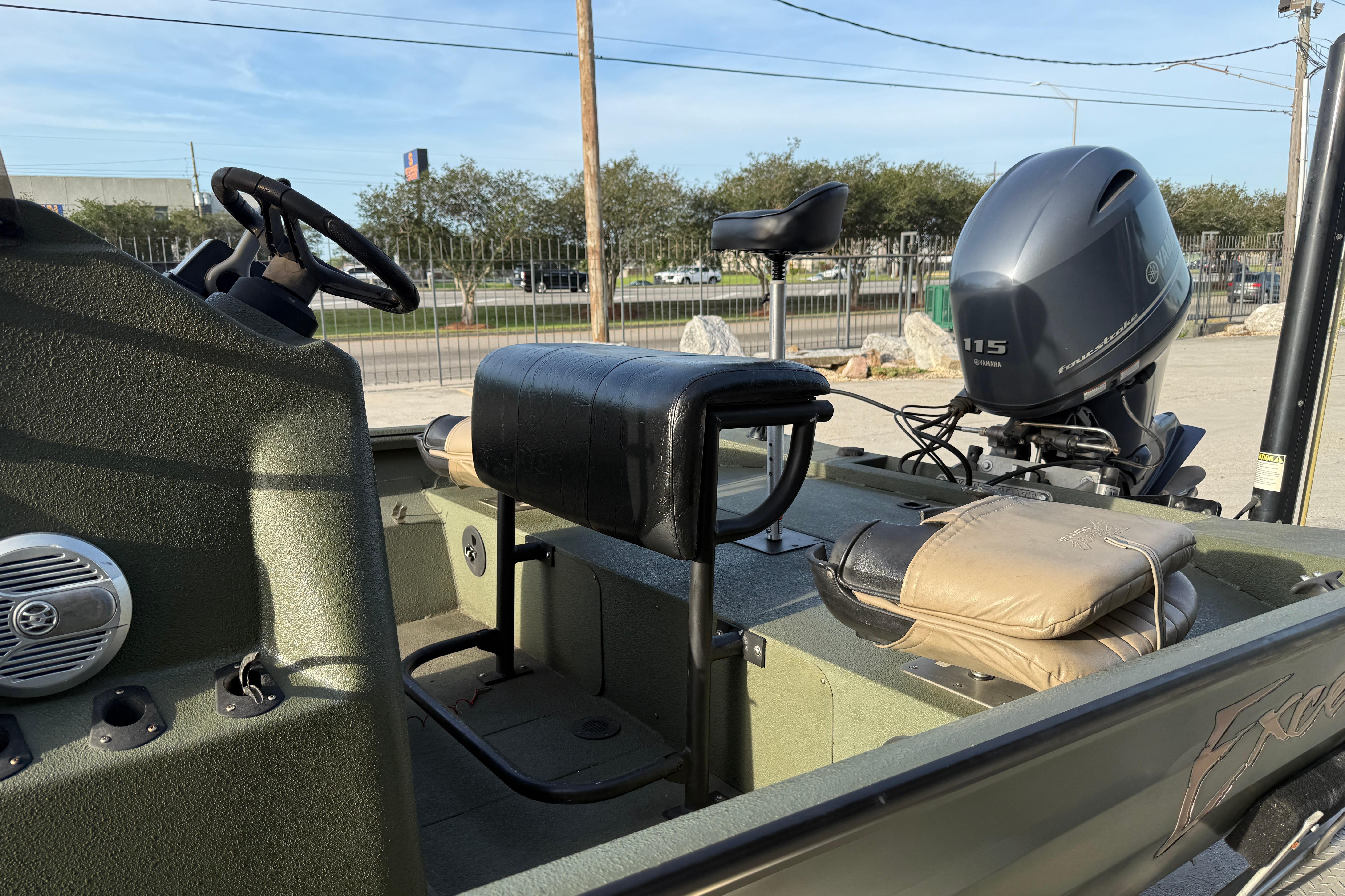 2014 Excel 203 Bay Pro boat interior with Yamaha 115 outboard motor, steering wheel, and seating.