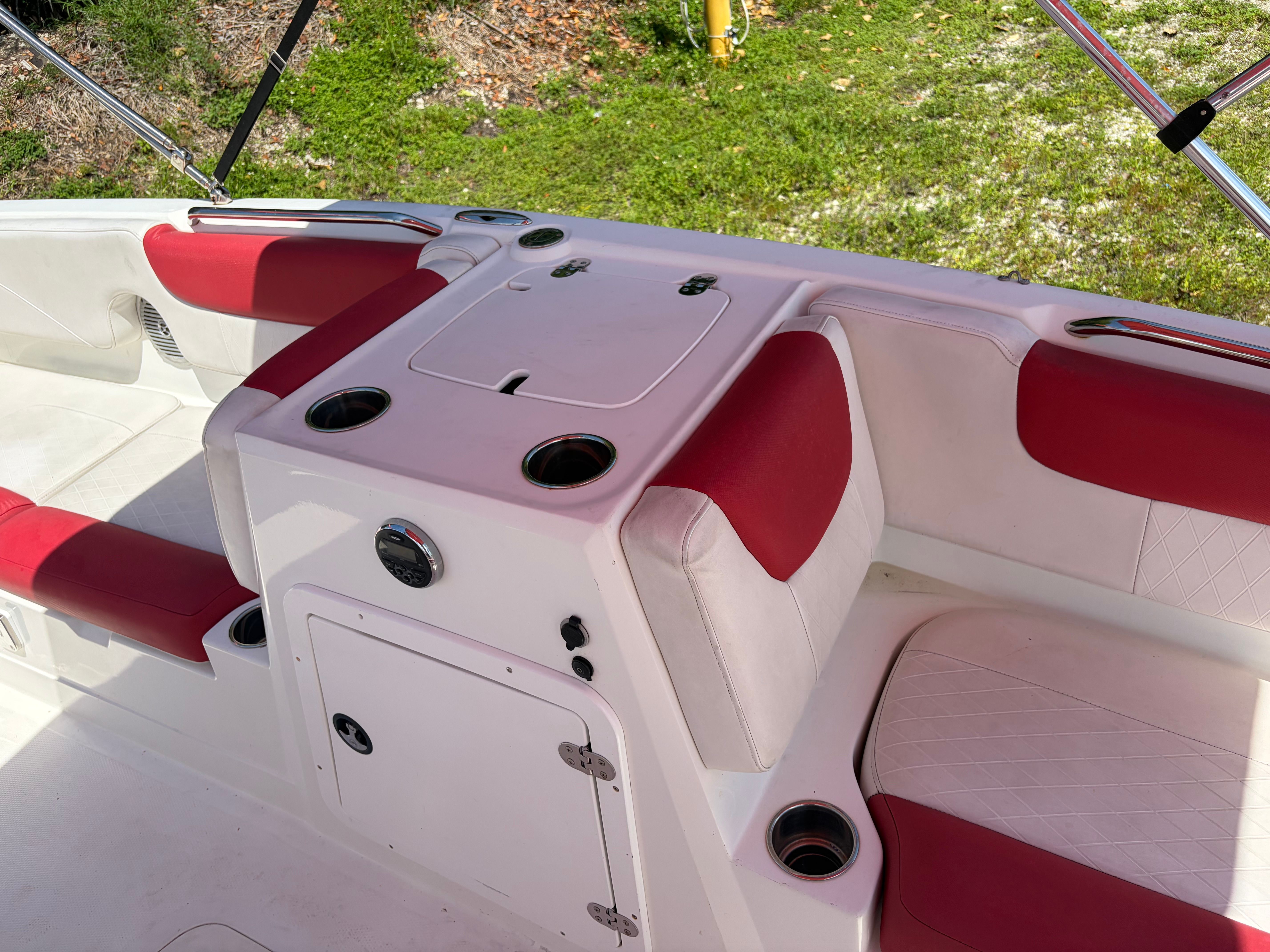 The image shows a boat cockpit with red and white seating.
