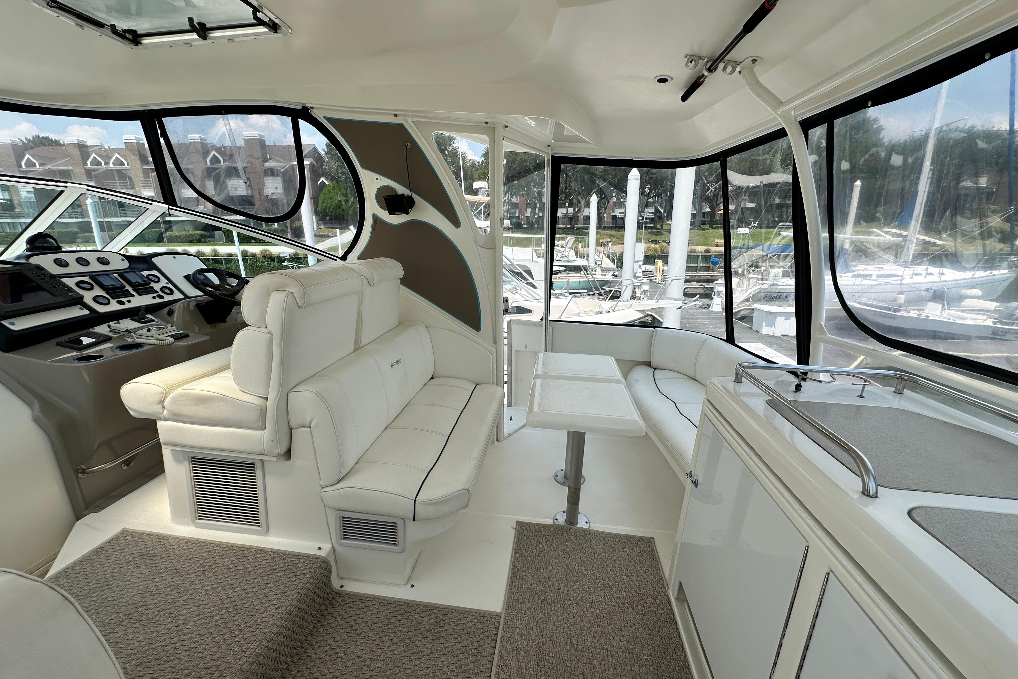 Luxurious interior of 2004 Cruisers Yachts 405 Express Motoryacht with plush seating and helm.