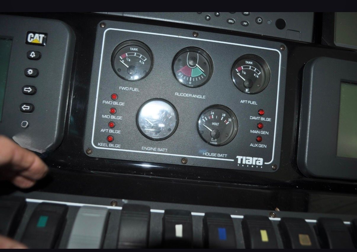 Dashboard of the 2005 Tiara Yachts 5200 Sovran with various gauges and switches.
