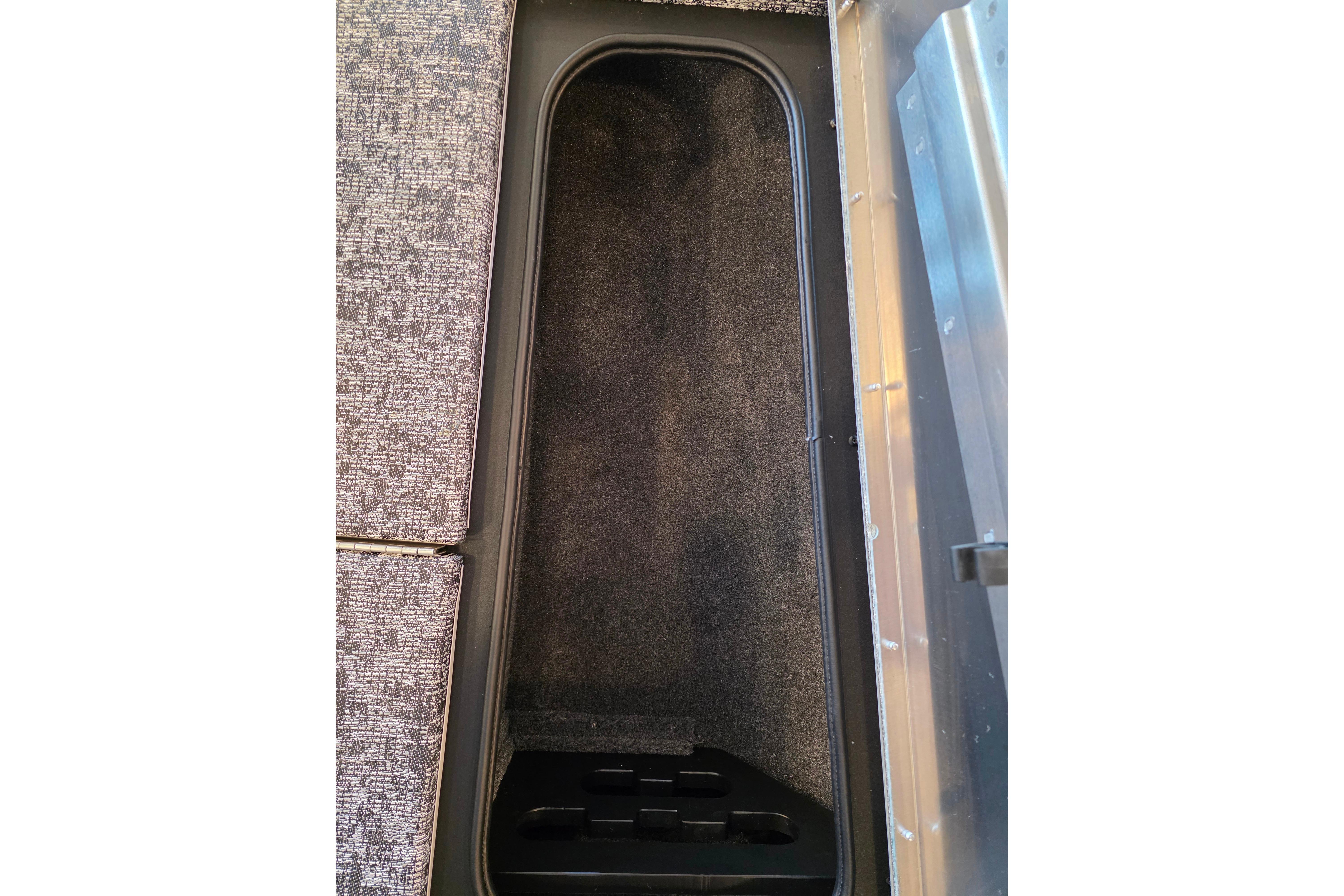 Storage compartment in 2026 Tracker Pro Team 175 Crappie Edition boat, featuring carpeted interior.
