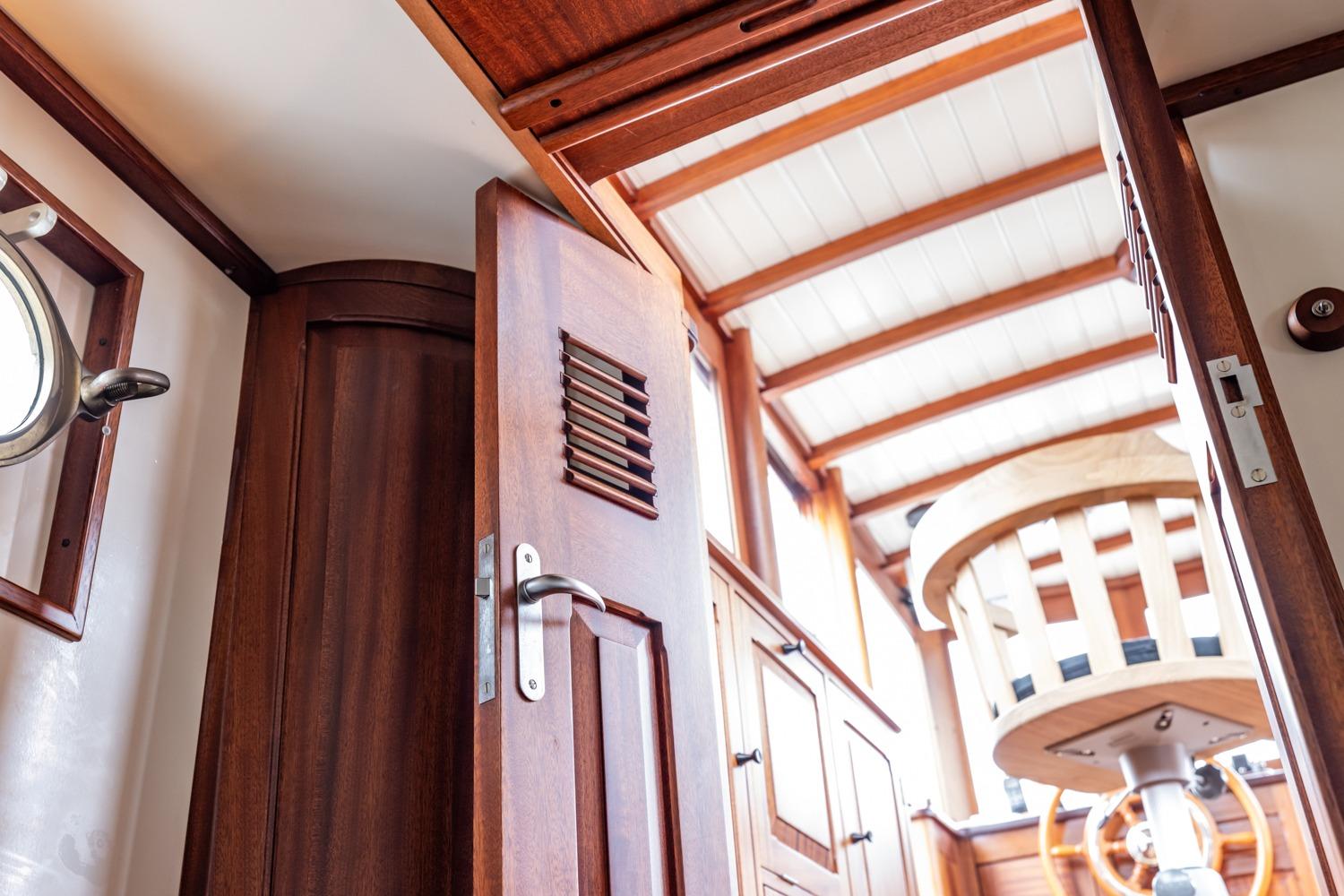 Interior of 1932 De Vries Lentsch Bromo yacht with wooden details and nautical decor.