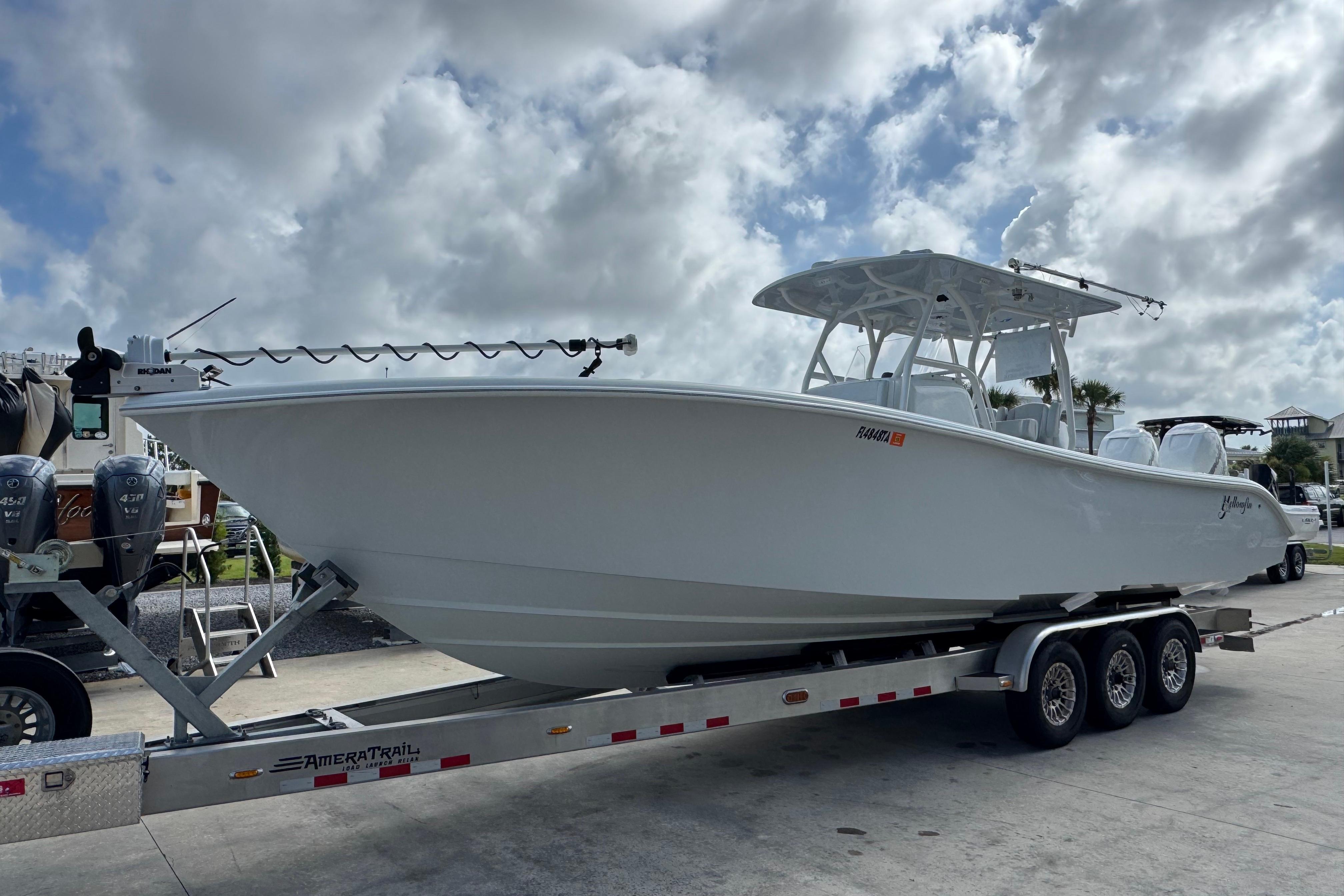2022 Yellowfin 32 Offshore boat on trailer under cloudy sky.