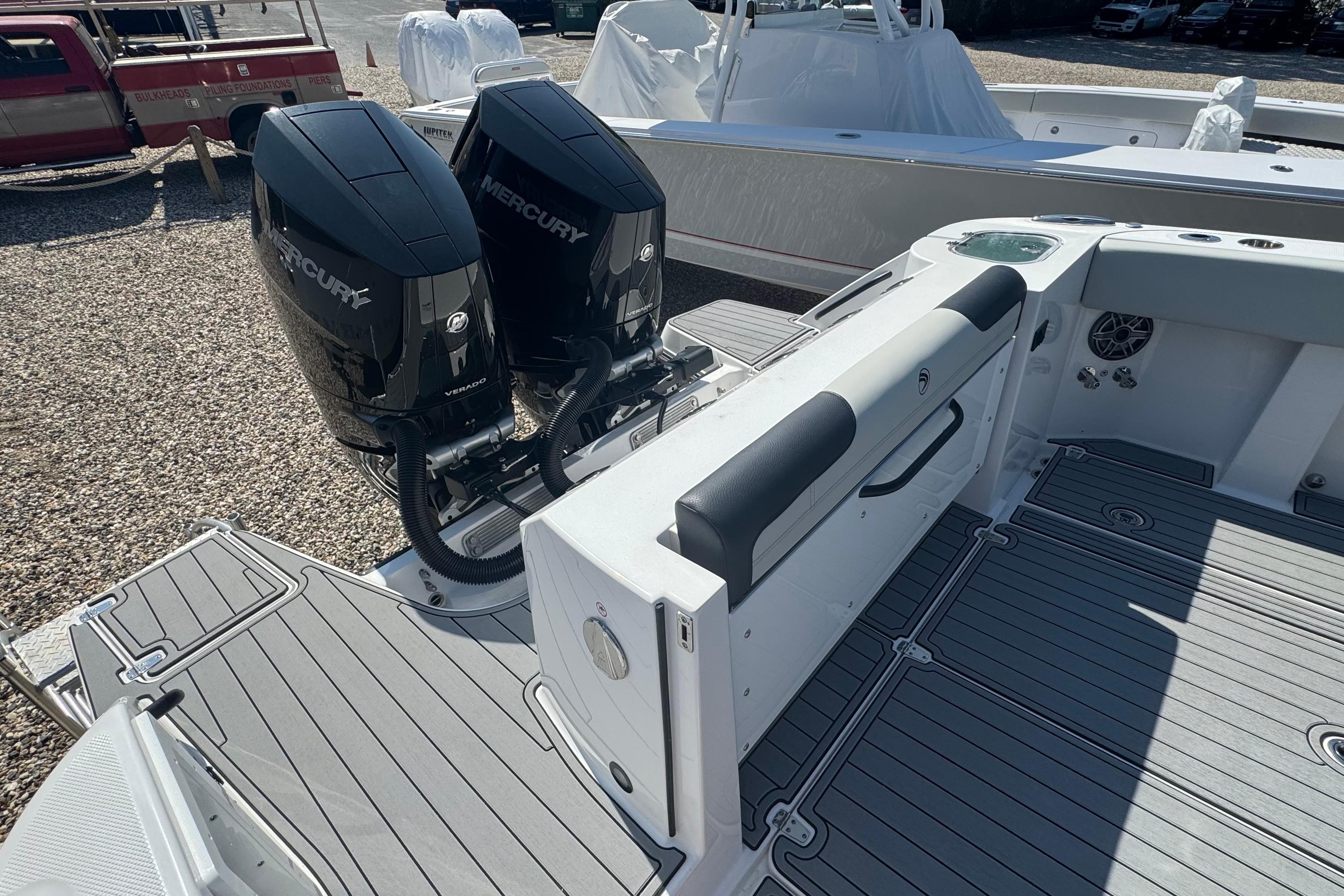 2025 Edgewater 340CC boat with dual Mercury engines, featuring spacious deck and seating area.