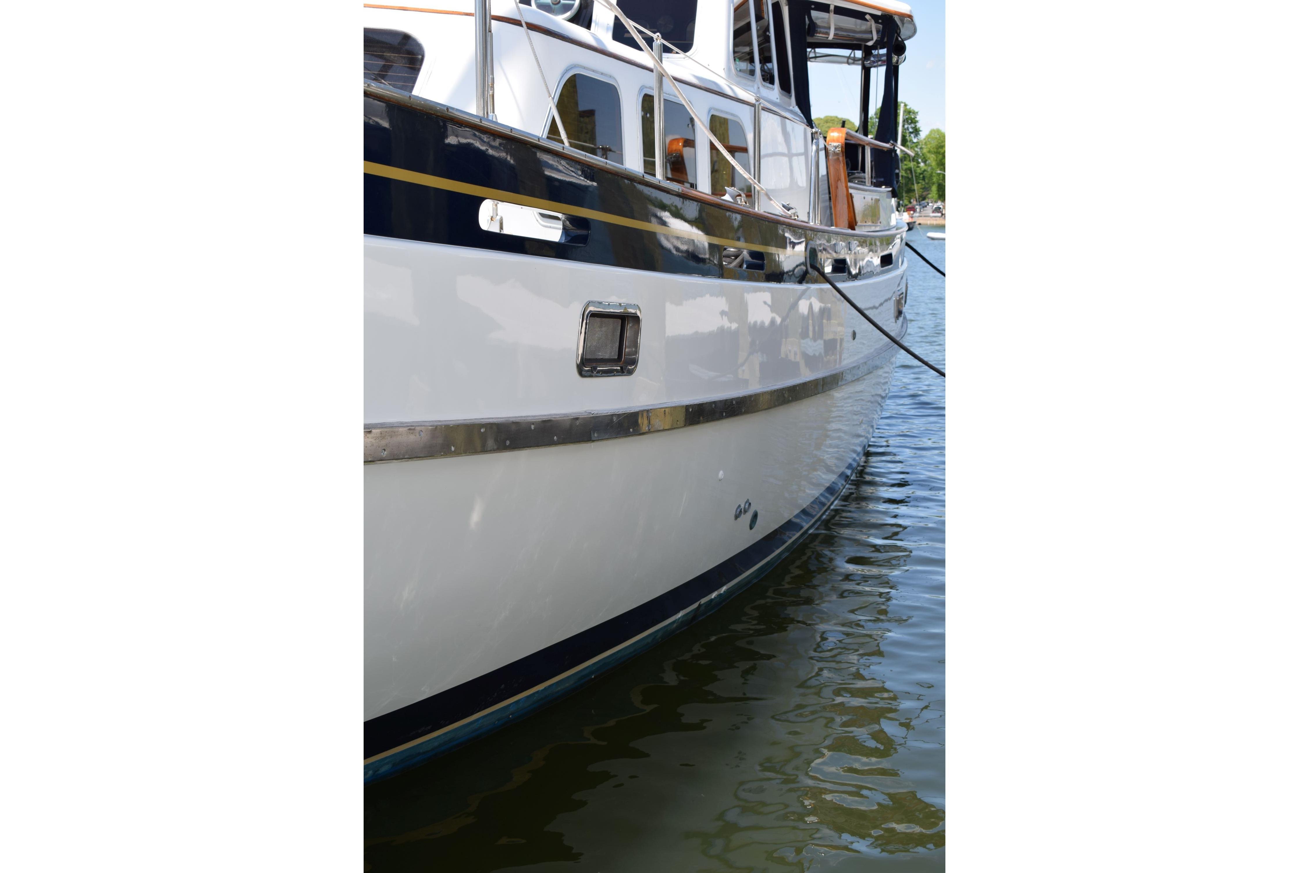 1980 Cheoy Lee 52 Motorsailer yacht docked on calm water.