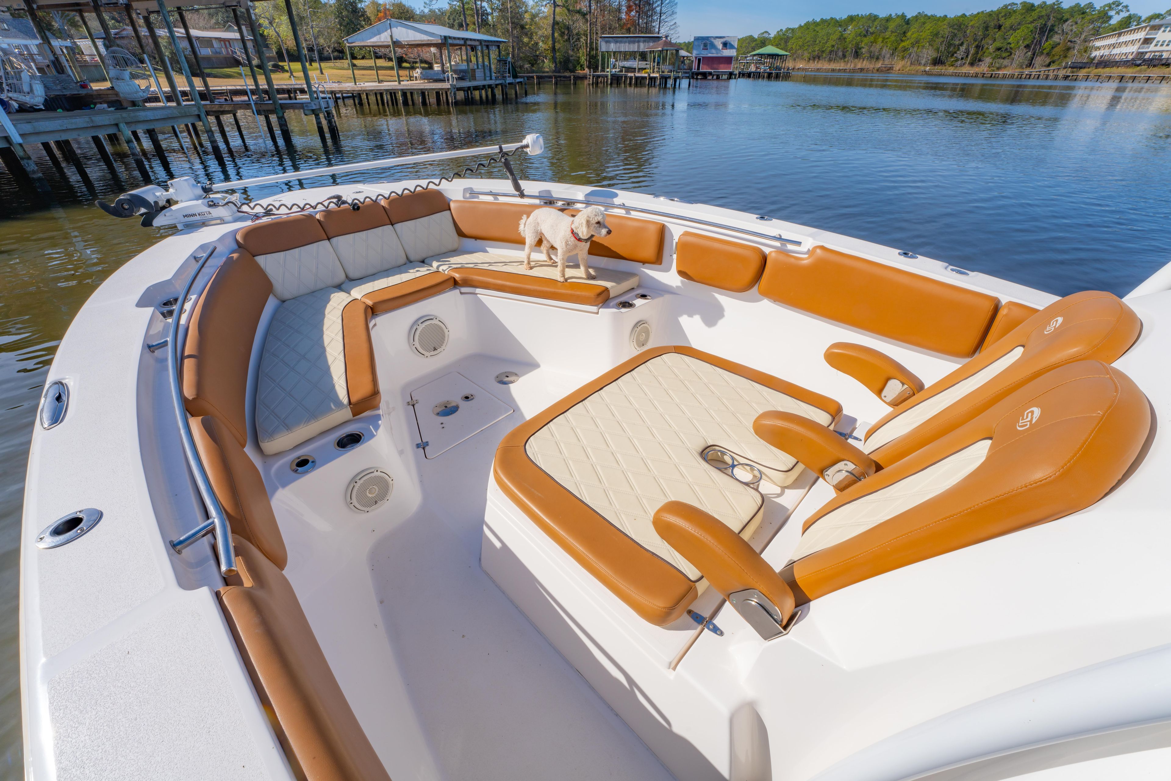 2019 Sea Fox 328 Commander boat interior with tan seating and a small dog.