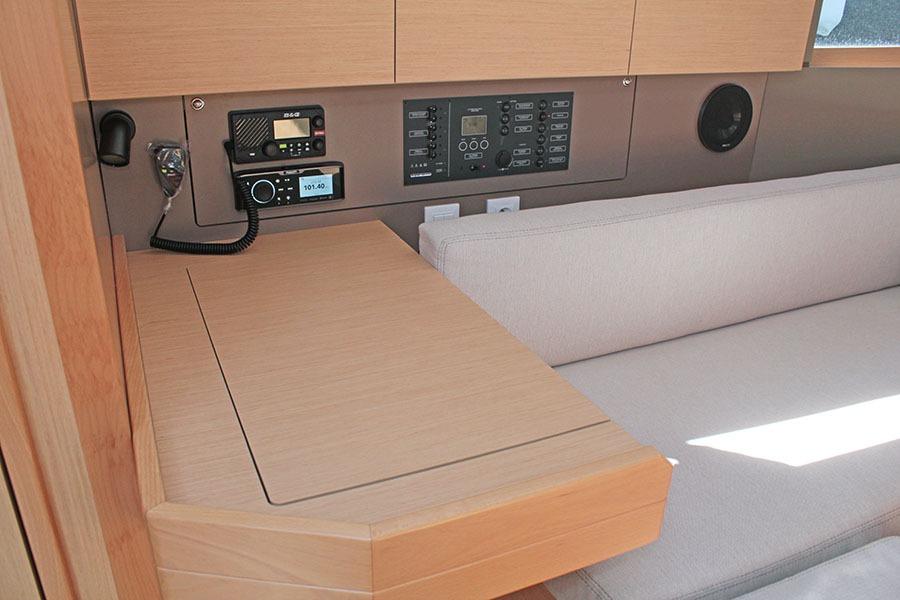 Interior of 2019 Beneteau Oceanis 38.1 yacht with navigation equipment and seating area.
