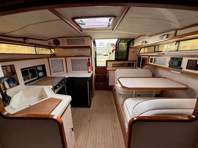Interior of a 1989 Sea Ray 340 yacht with kitchen and seating area.