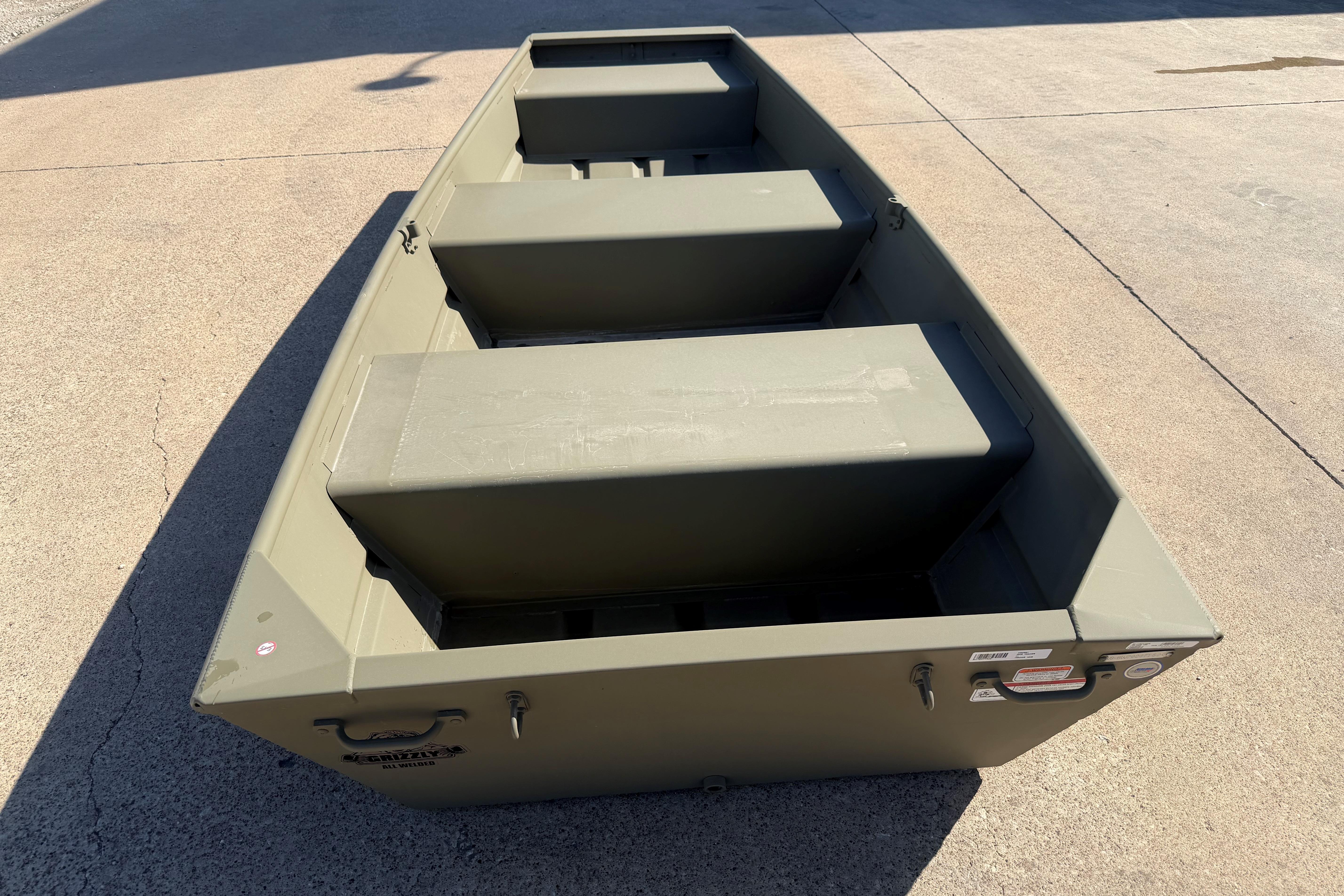 2026 Tracker Grizzly 10 Jon boat on concrete surface, showcasing interior seating.