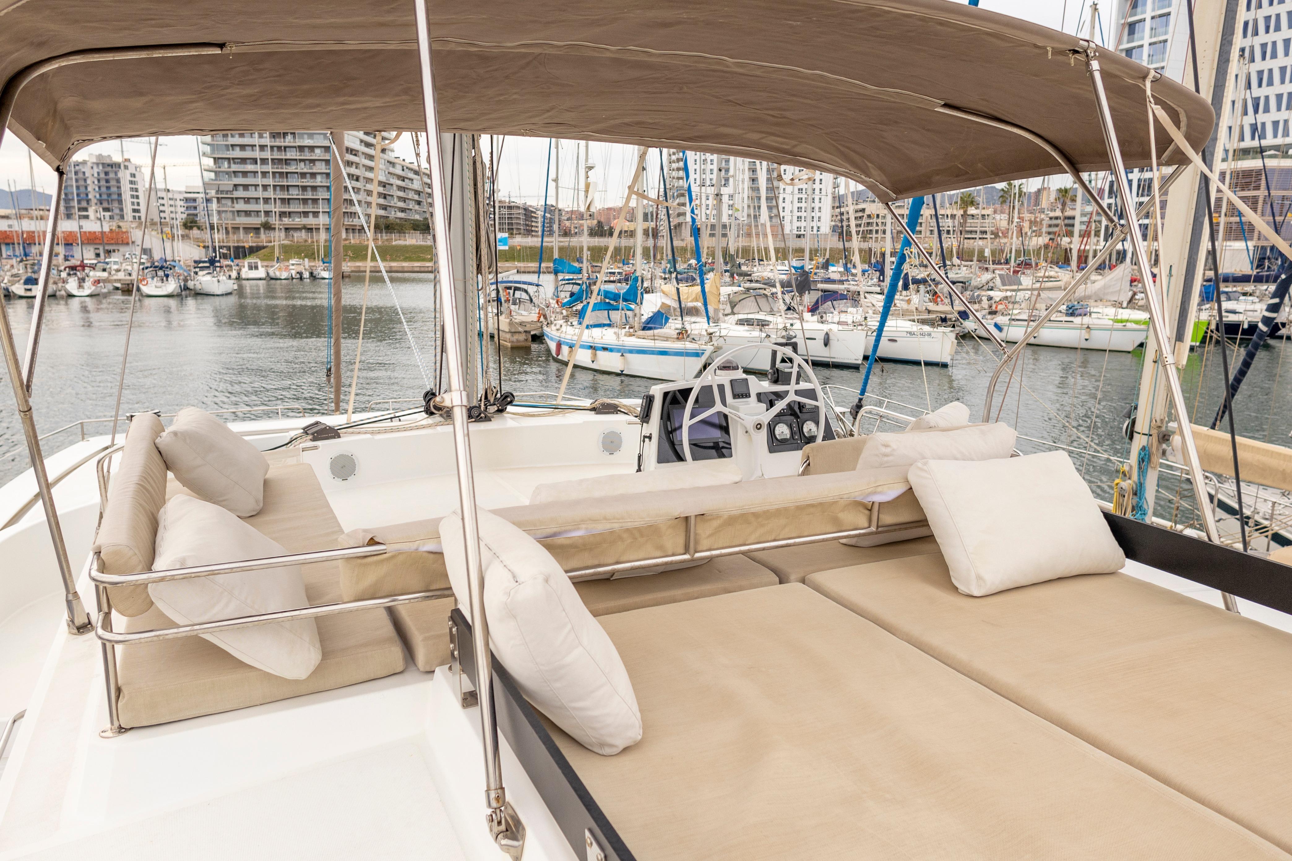 Luxurious 2020 Bali 4.8 catamaran with spacious deck and comfortable seating in marina.