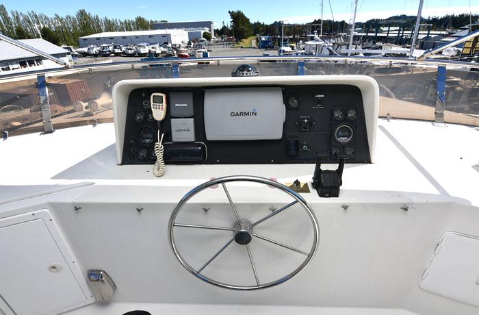 Pilothouse helm of 1997 Forbes Cooper 74, featuring Garmin navigation and communication equipment.