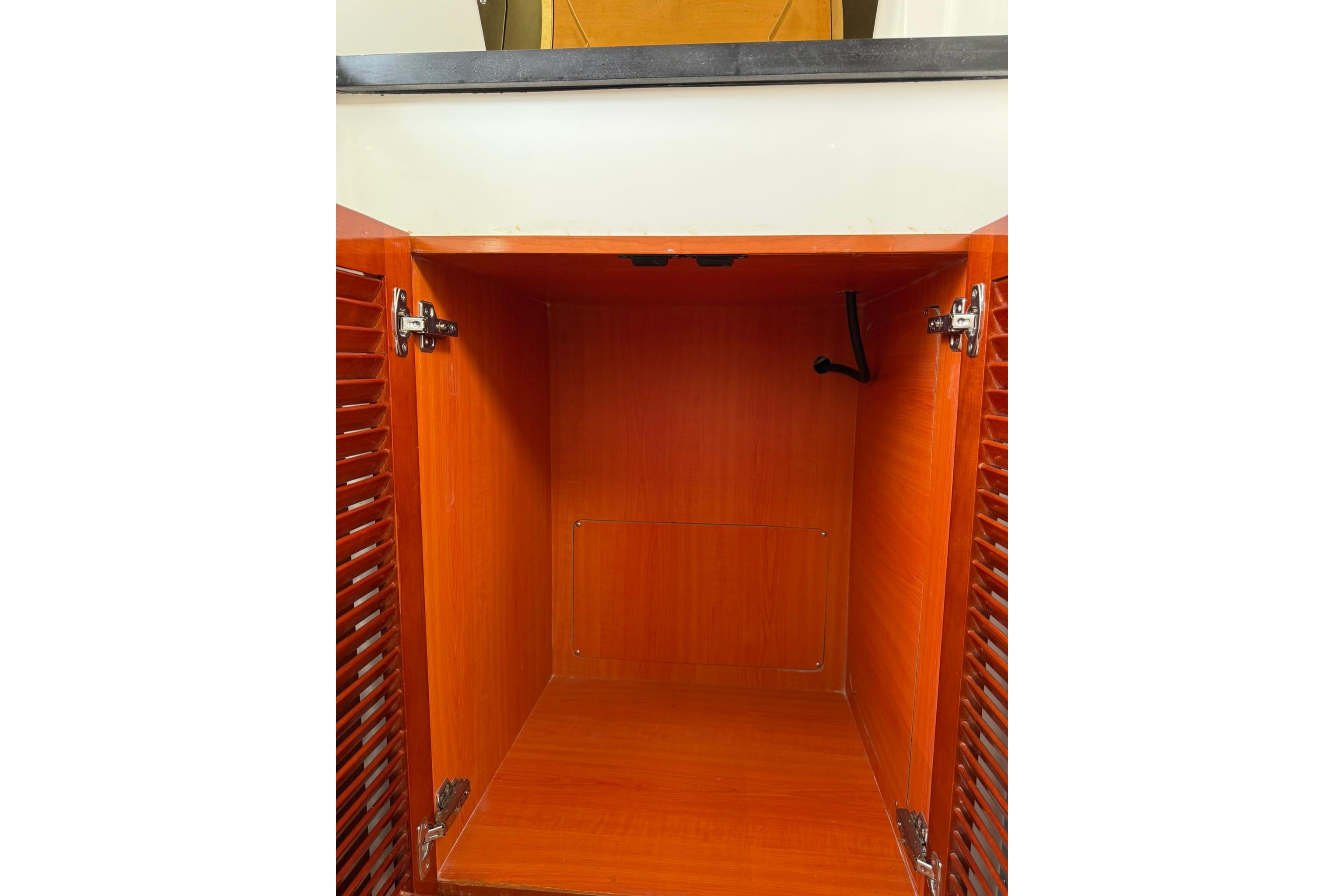 Empty wooden cabinet interior on a 2020 SeaPiper 35 boat.