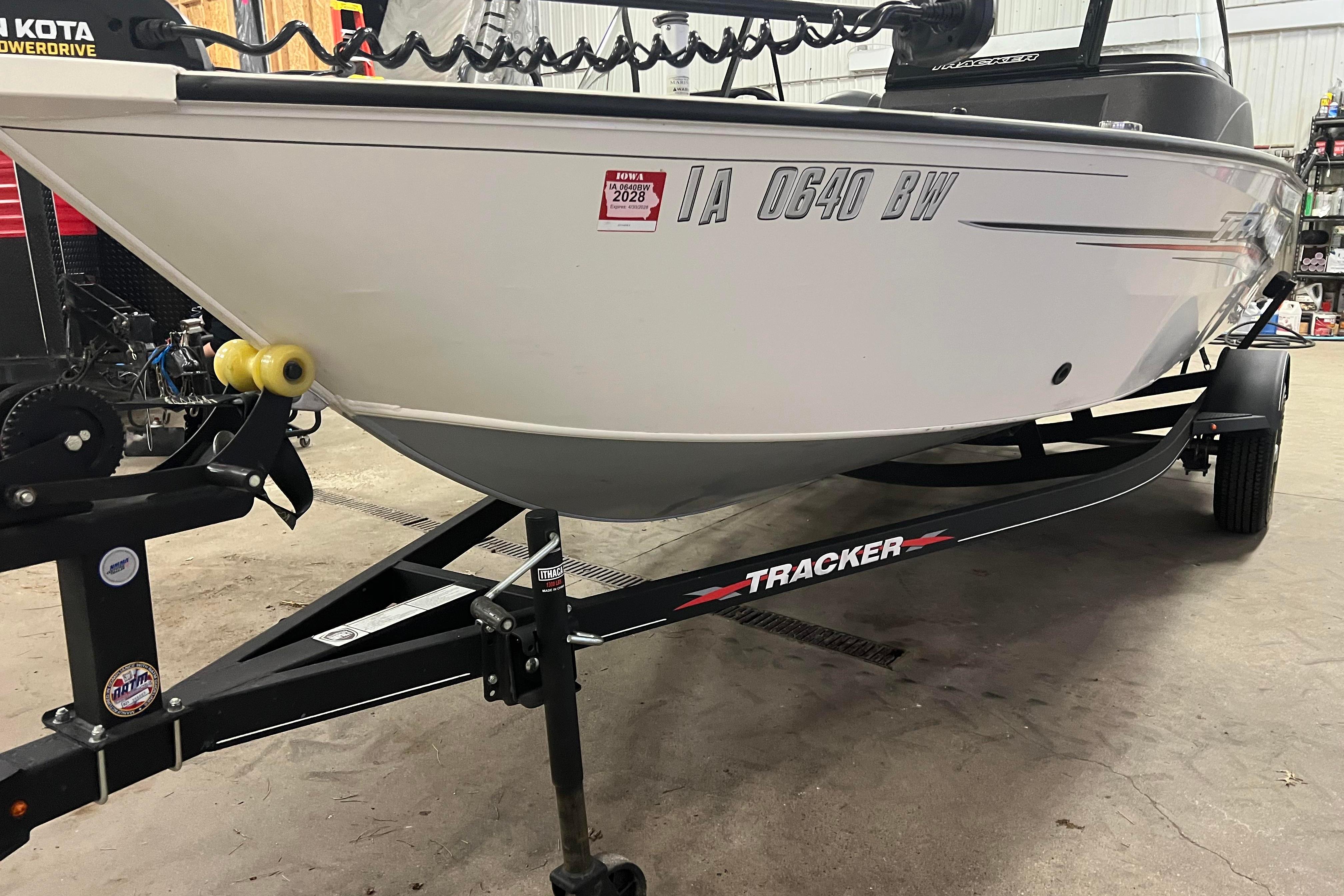 2022 Tracker Pro Guide V-16 WT boat on trailer in garage setting.