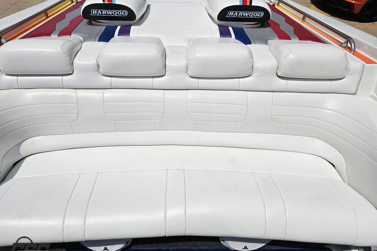2002 Formula 382 FASTech boat interior with white leather seating and Harwood branding.