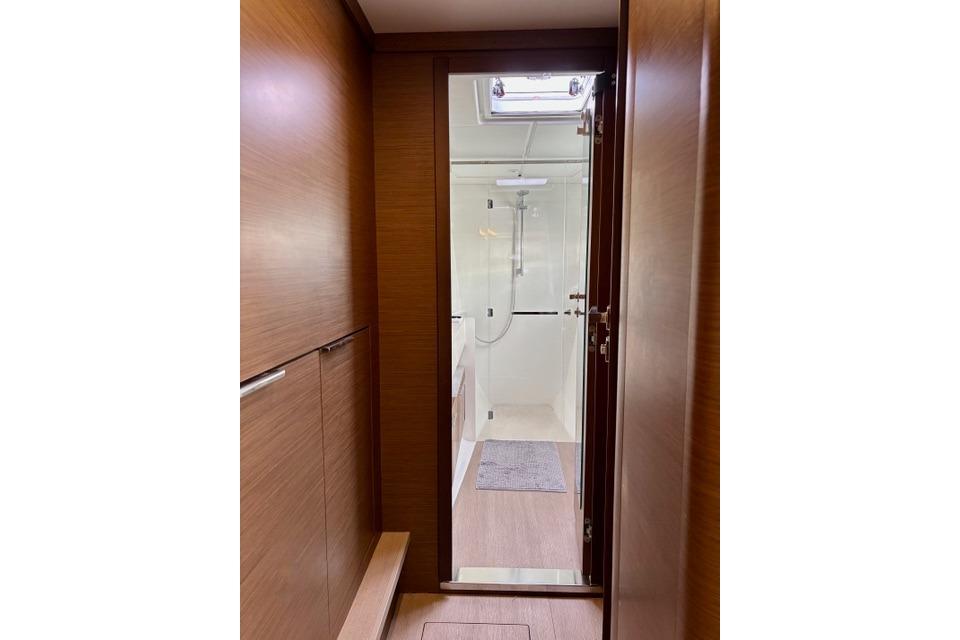 Interior view of 2022 Lagoon 46 yacht bathroom with wooden finish and modern shower.