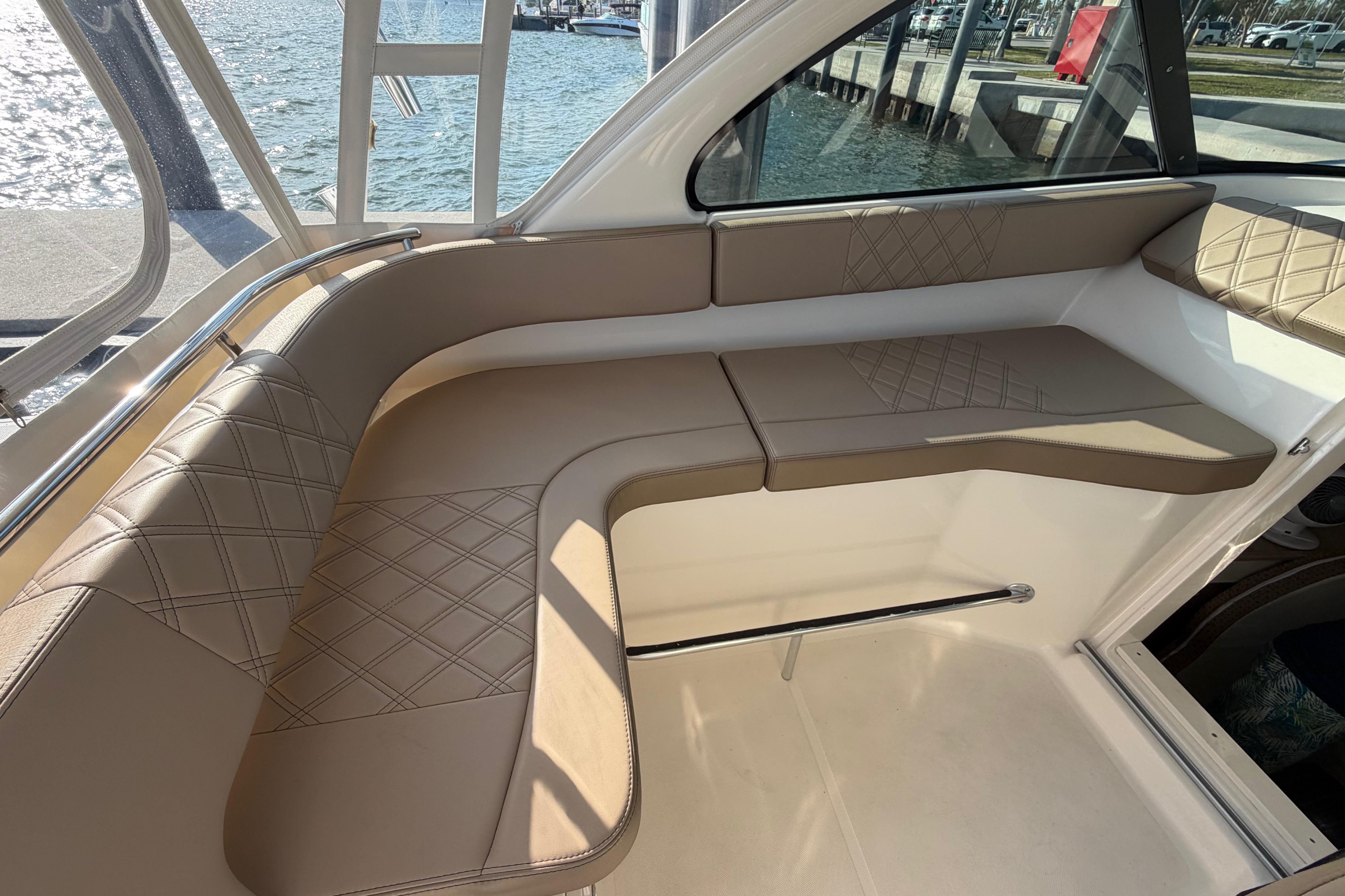 Luxurious seating area on a 2009 Pursuit OS 315 Offshore boat, featuring diamond-stitched upholstery.