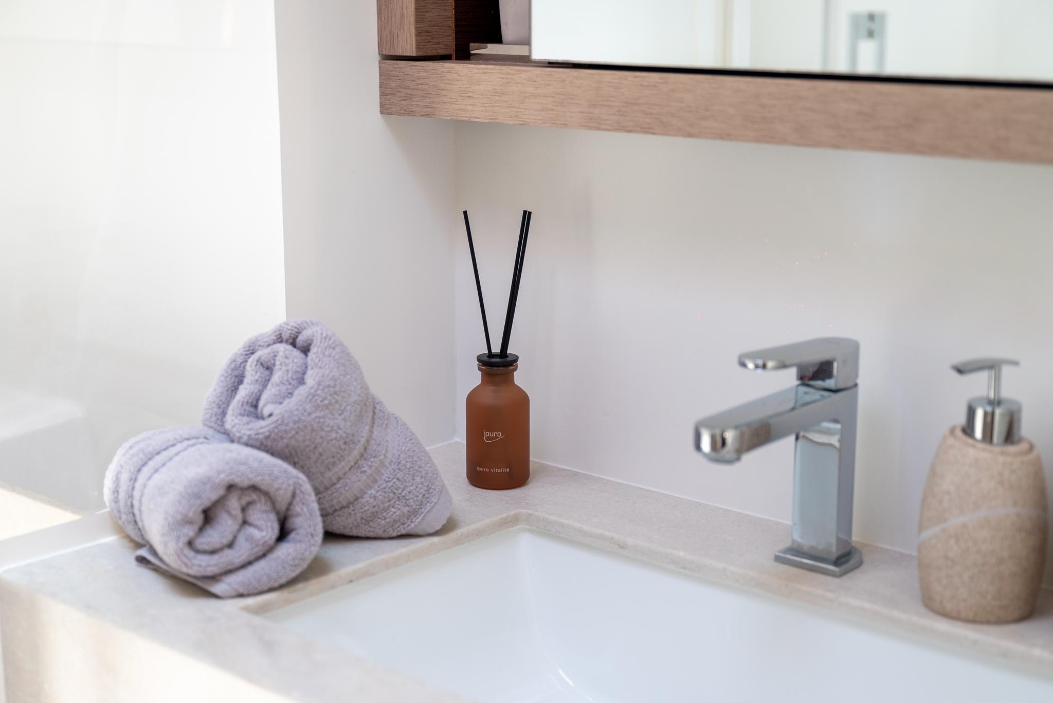 Luxury bathroom sink with towels and diffuser on Lagoon SIXTY 5 yacht, 2024 model.