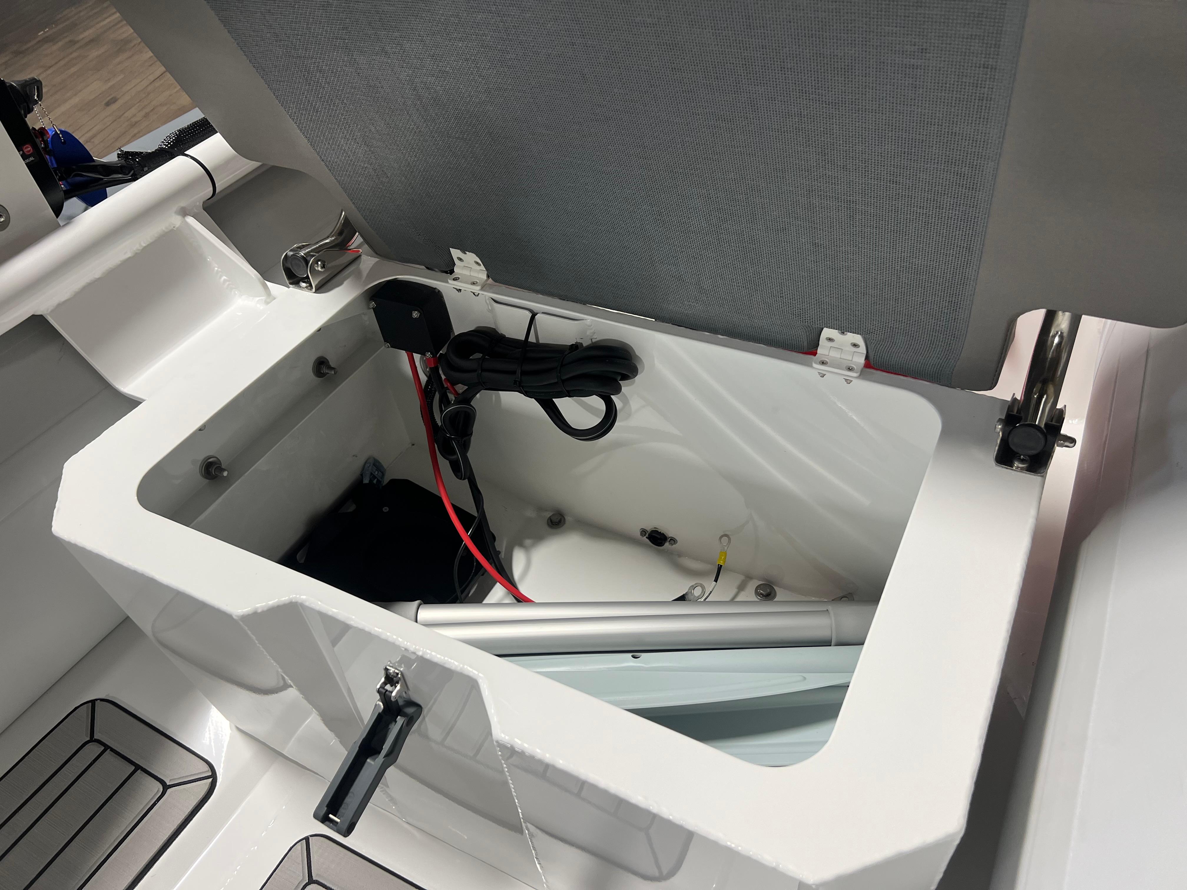 Open storage compartment of 2023 Gala A330Q boat with wiring and equipment.