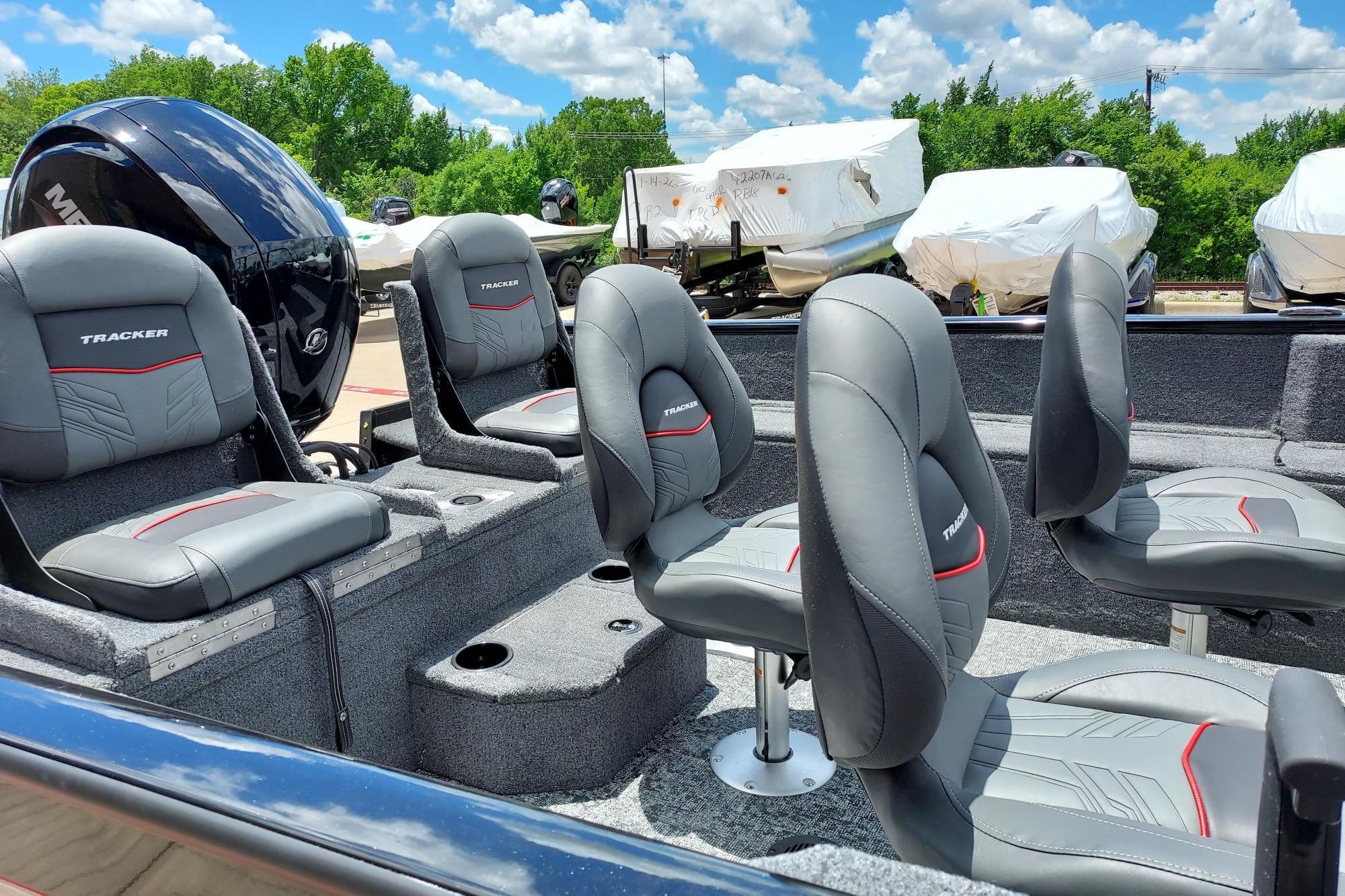 2026 Tracker Pro Guide V-175 Combo boat interior with gray seats and outboard motor.