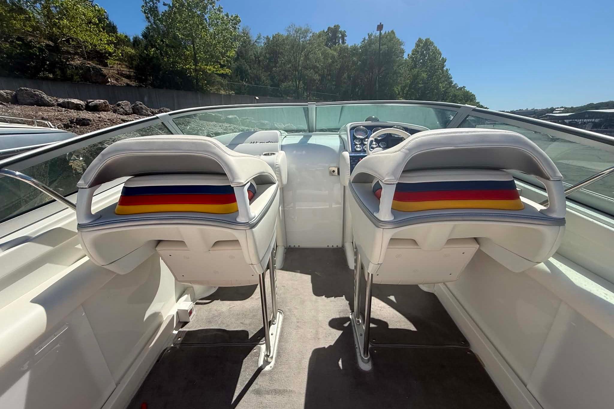 2007 Formula 353 FASTech boat interior with dual white seats and colorful cushions.