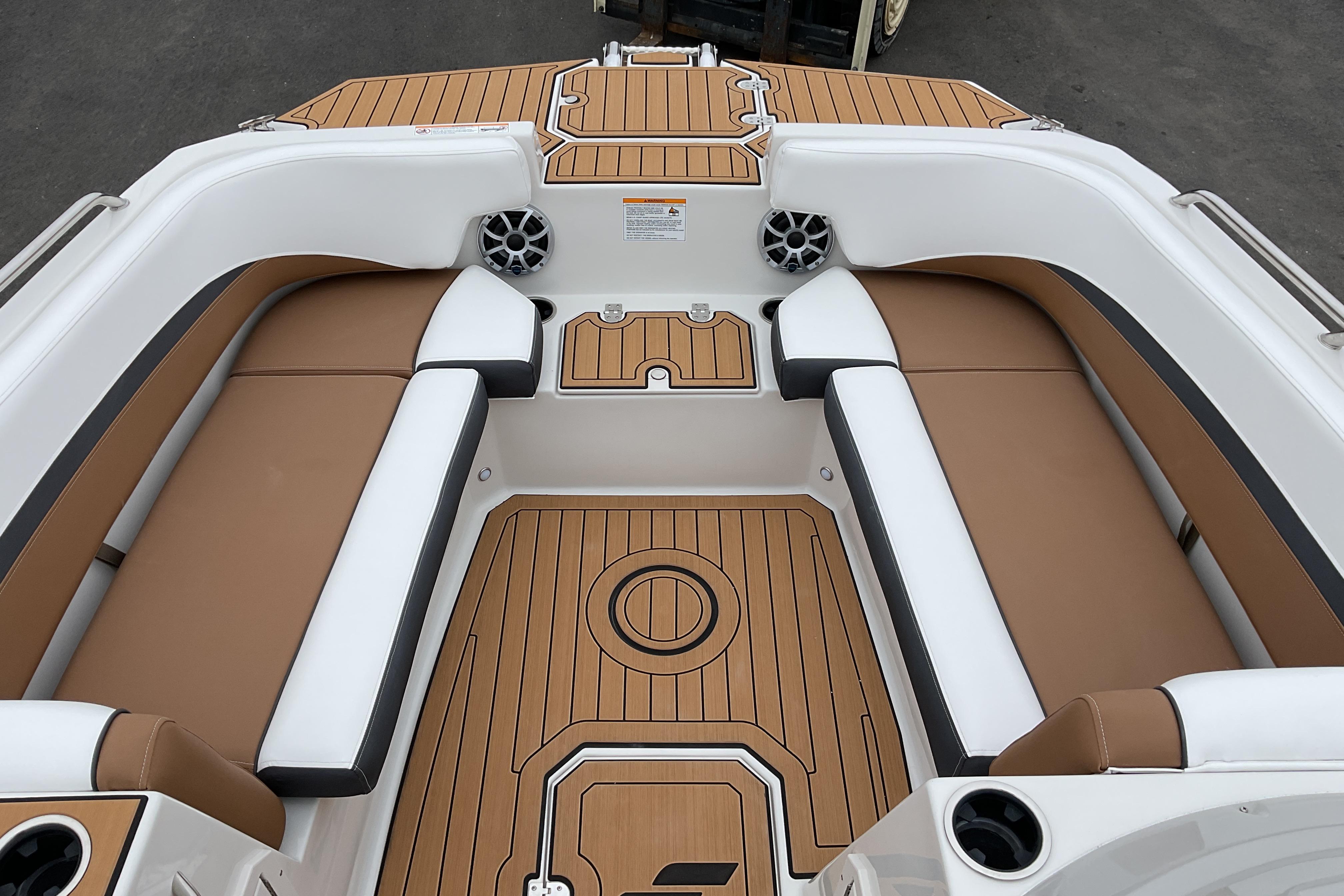 2026 Starcraft SVX 211 OB boat interior with tan and white seating, teak-style flooring.