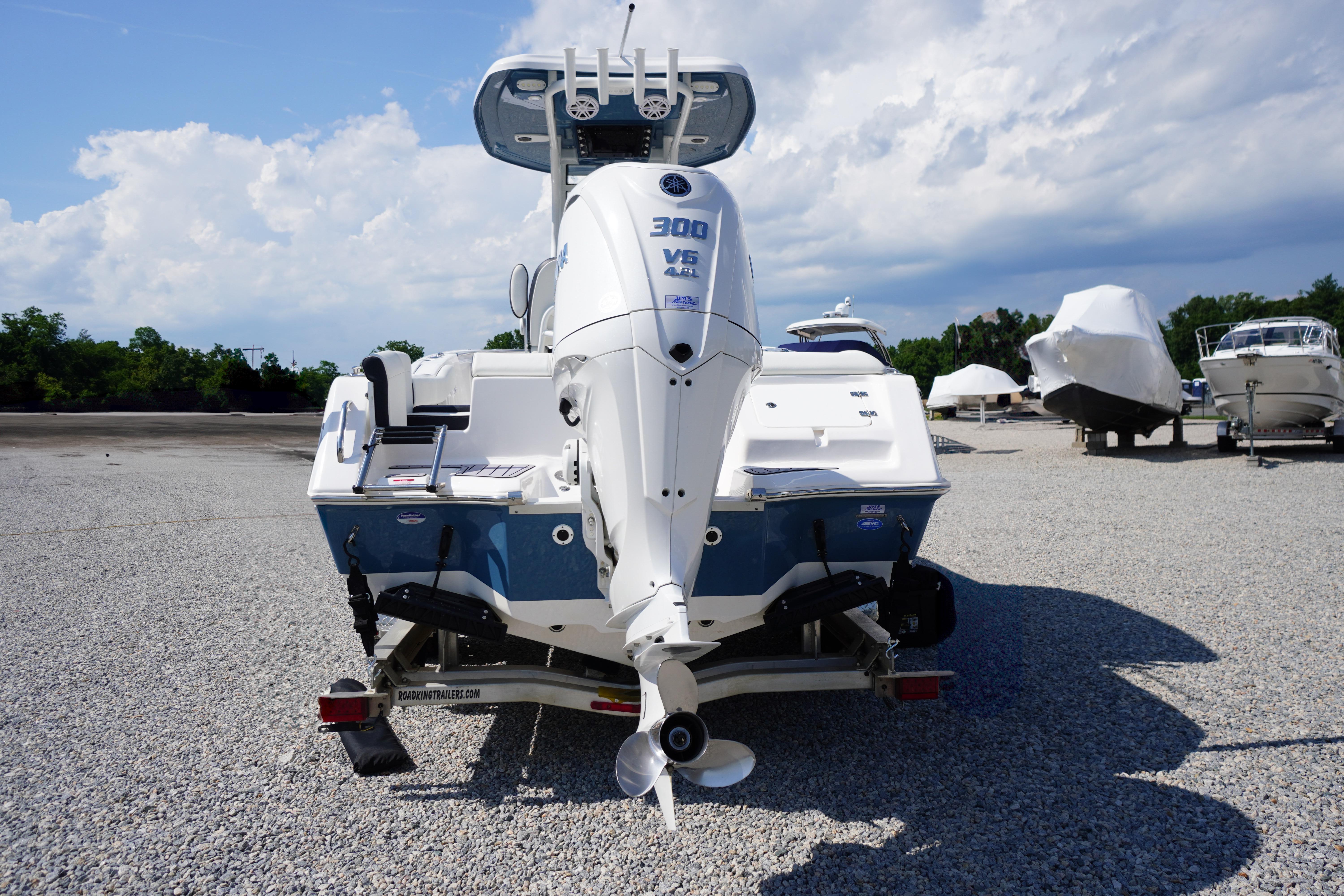 2025 Tidewater 232 SS boat with powerful 300 V6 engine, parked on gravel lot.