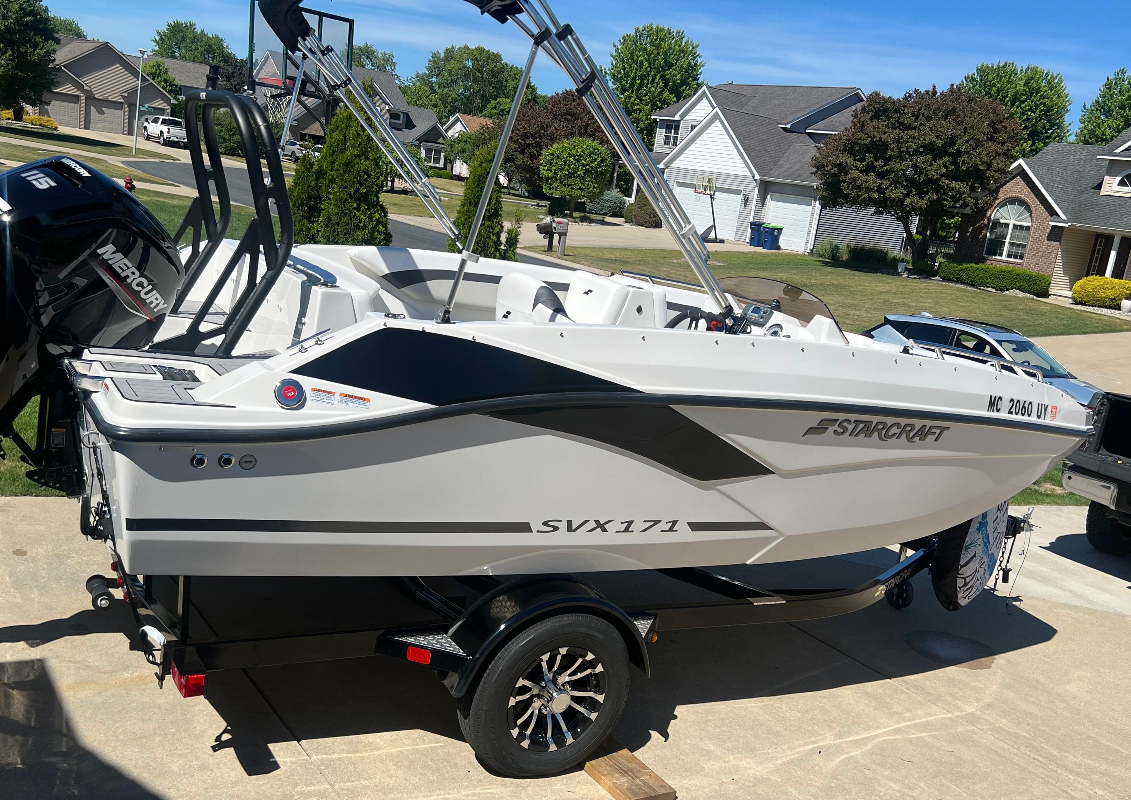 2023 Starcraft SVX 171 OB boat on trailer in residential area.