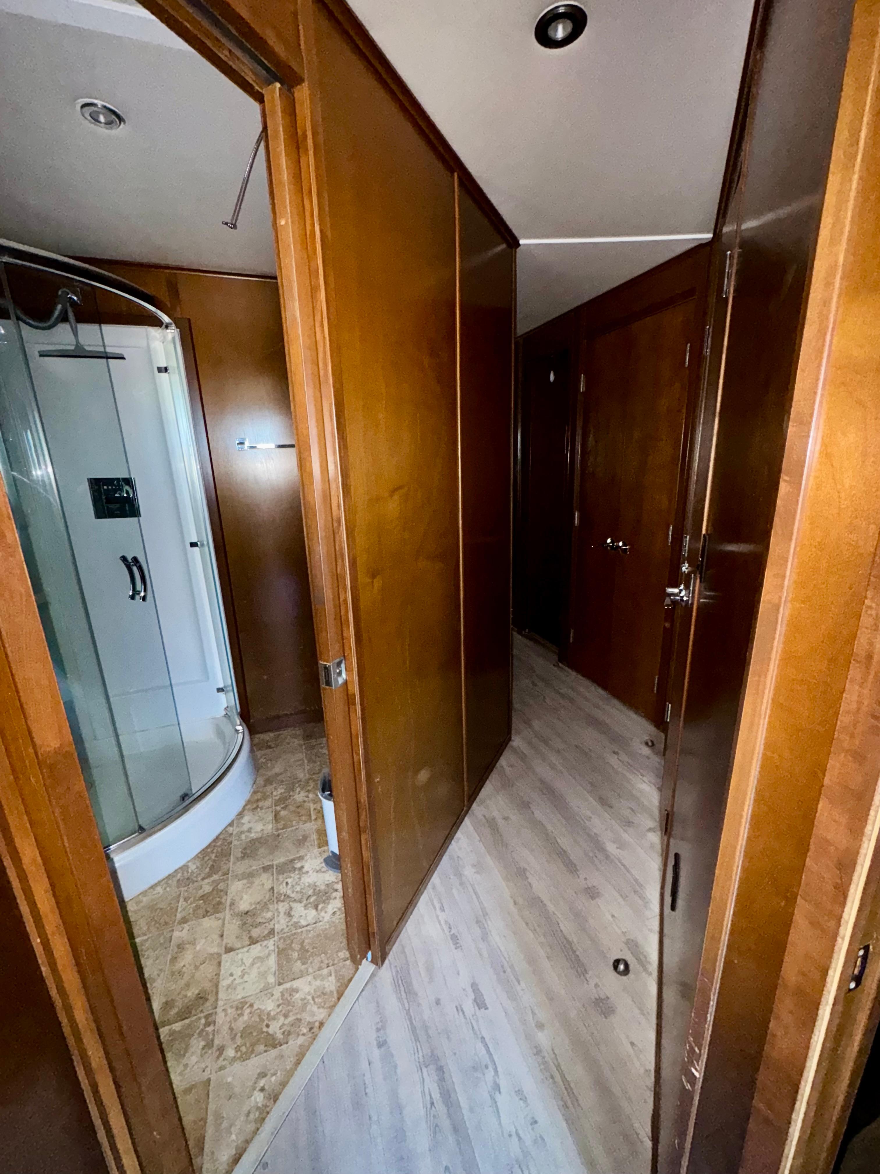 Interior hallway of 2013 Bravada Bella Luna Share #8 with wooden doors and modern shower.