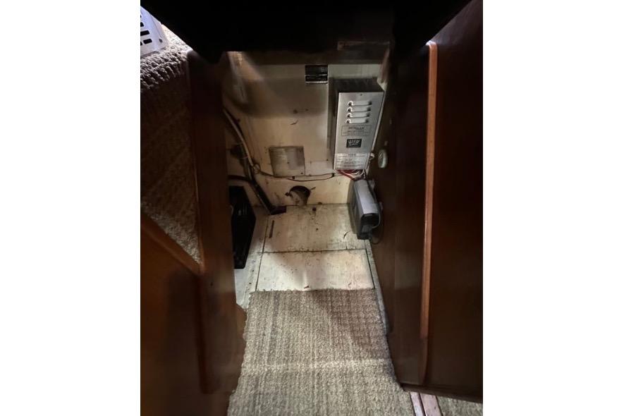 Interior view of 1985 Egg Harbor 33 Sedan, showing electrical panel and carpeted flooring.