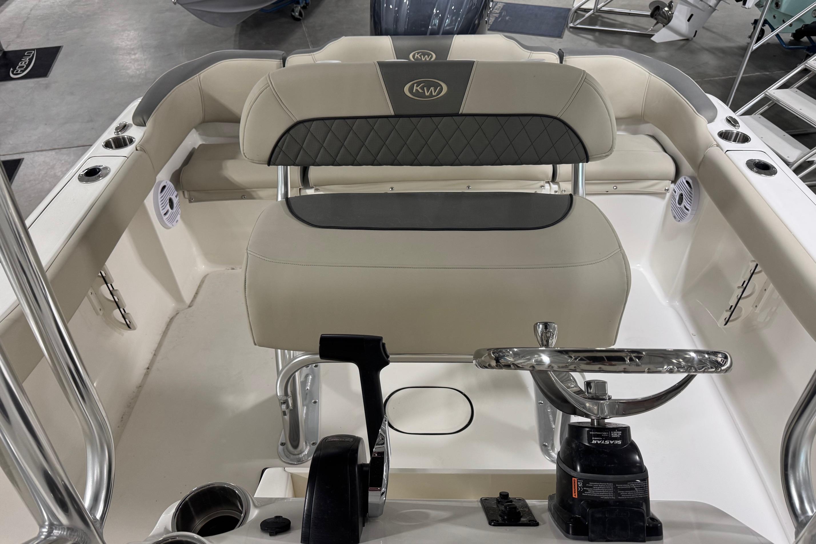 2026 Key West 203 FS boat interior with steering wheel and seating.